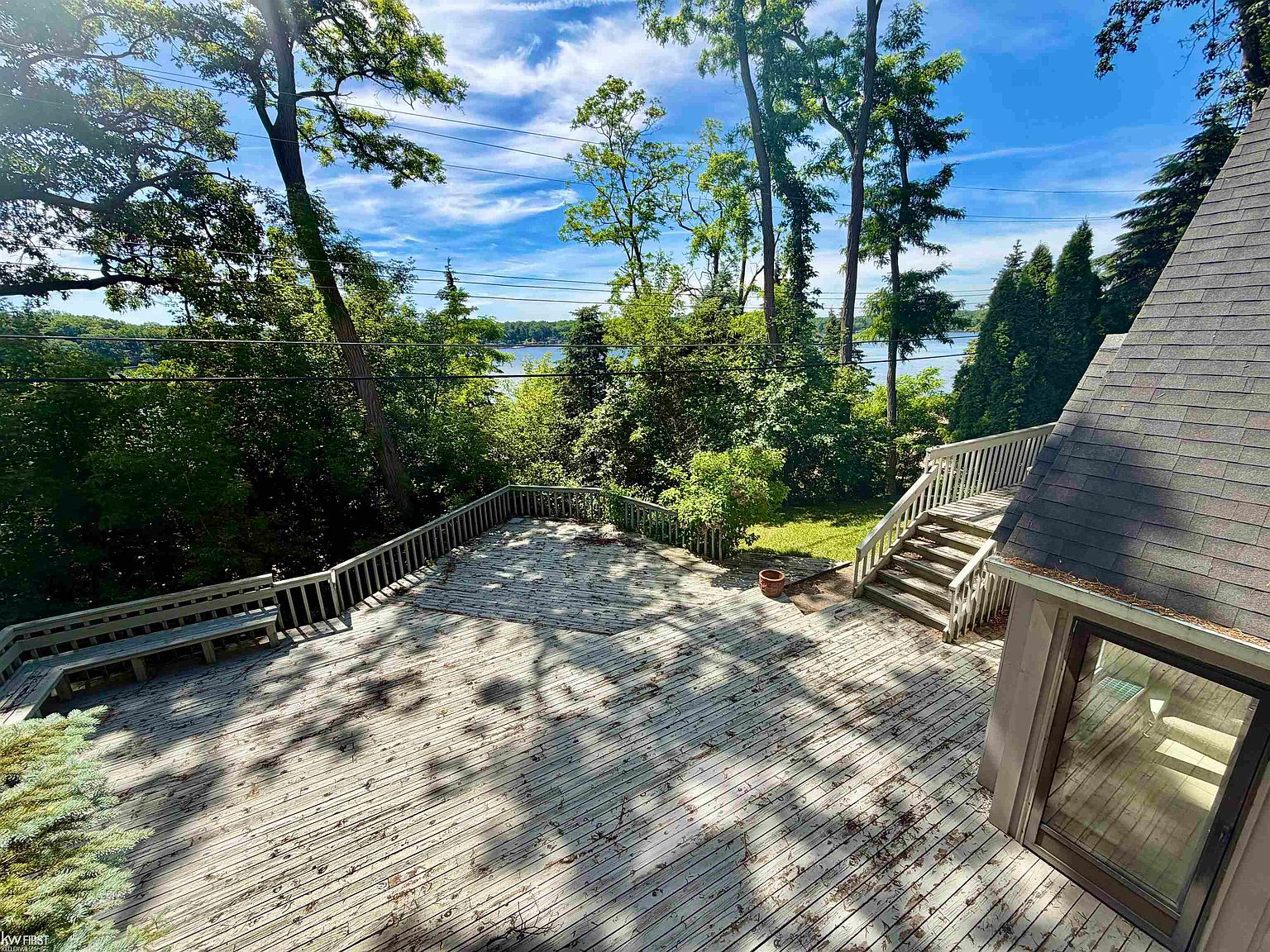 Elevated deck view with built-in bench seating overlooking the lake