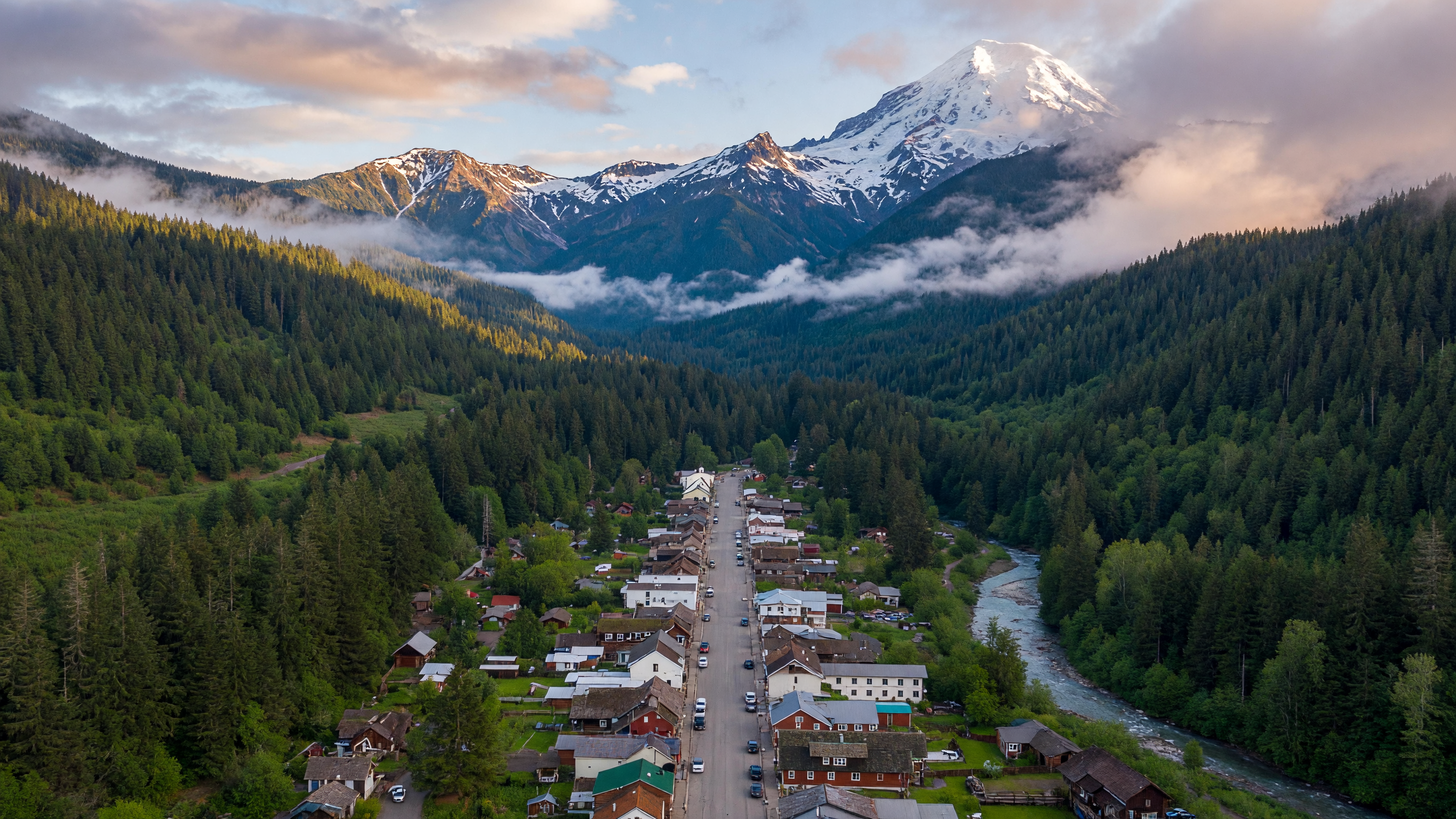 Packwood Washington alpine village nestled in a valley surrounded by evergreen forests and snow-capped Cascade Range peaks