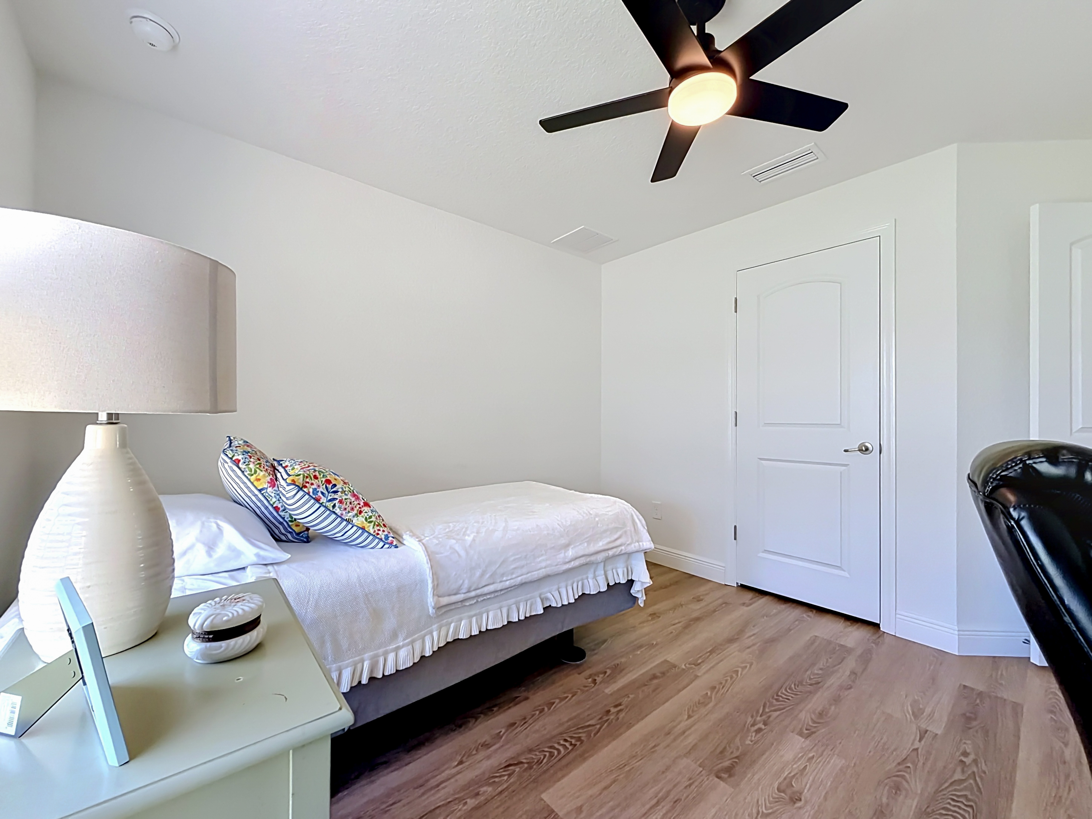 Guest bedroom with vinyl plank flooring
