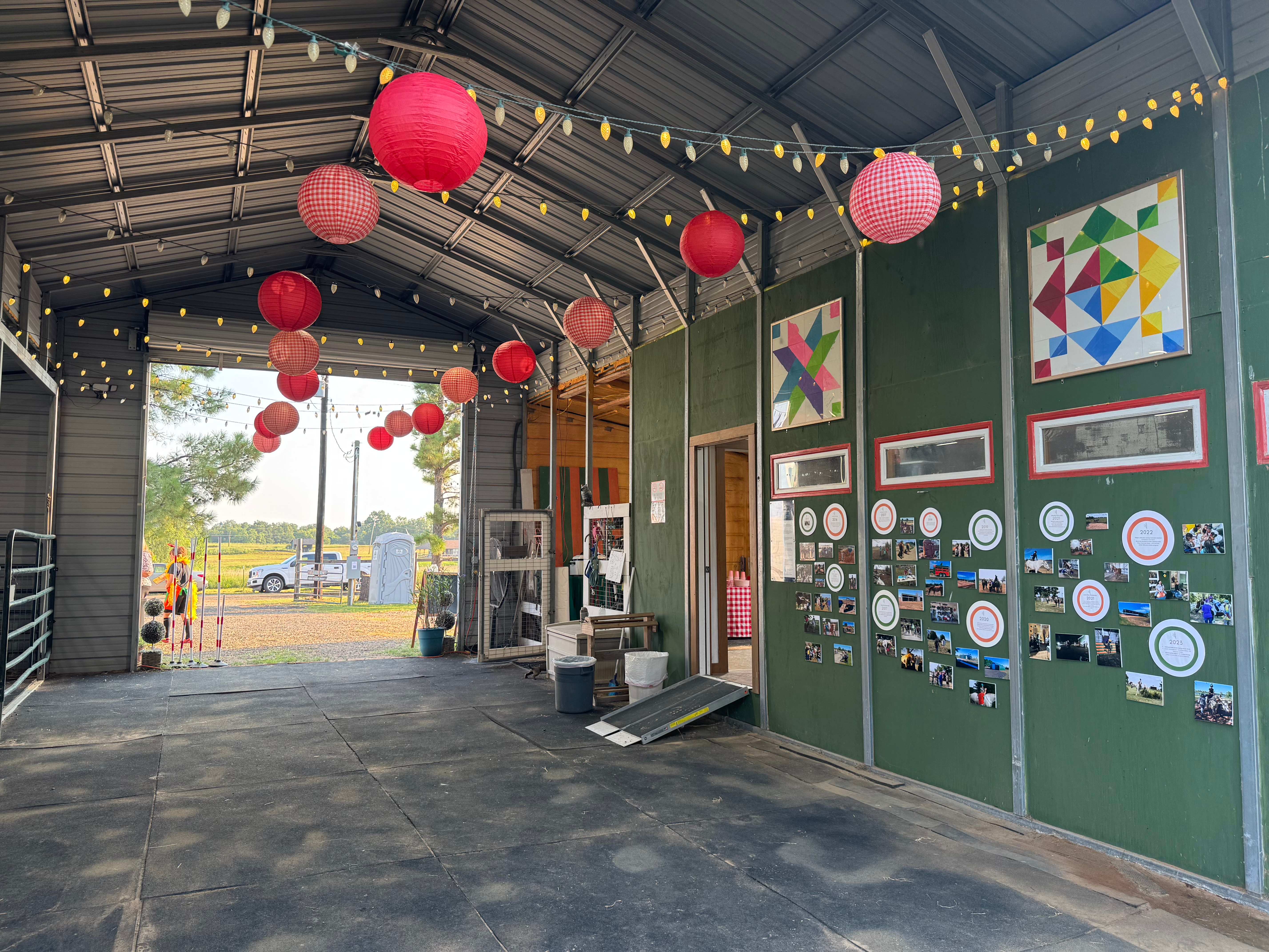 Rustic event barn decorated with red paper lanterns at a Tailored Rides community gathering