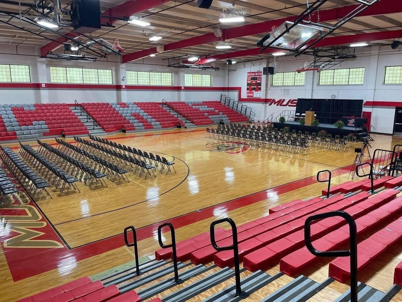 Interior of the Chisum ISD gymnasium with tiered bleachers and event seating