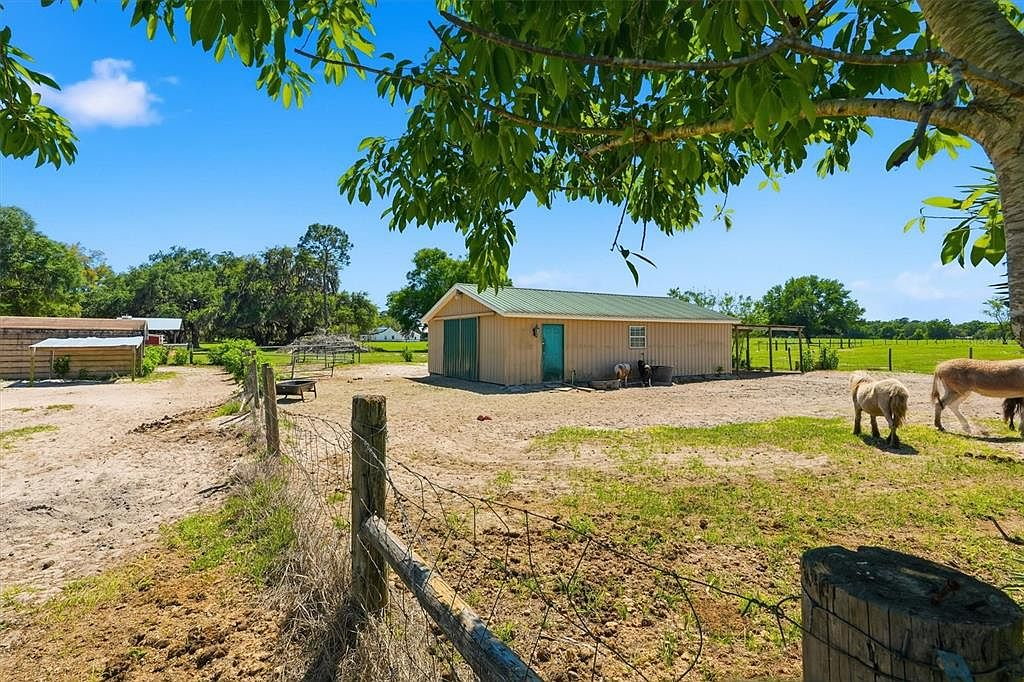 Equipped barn with pasture, fencing, and livestock