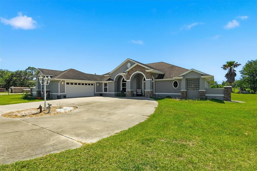 Angled front view with landscaped driveway