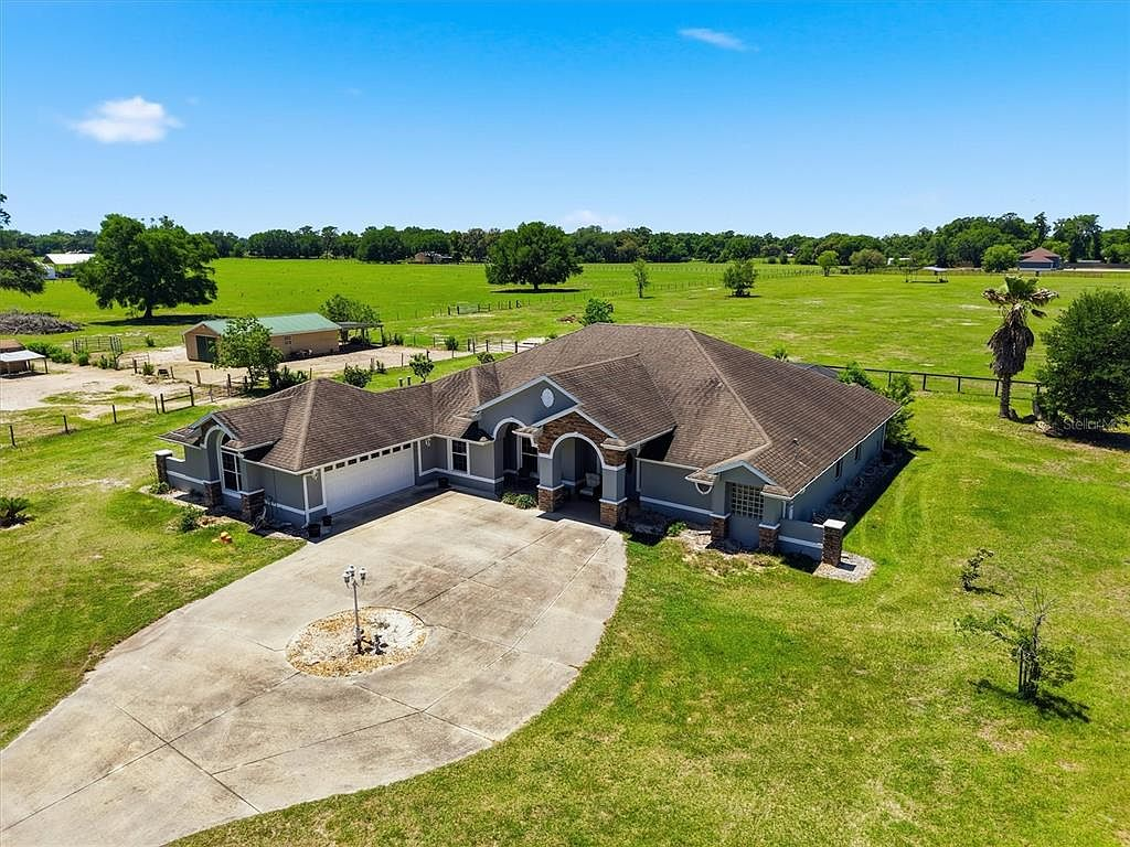 Aerial drone shot showing the home on expansive rural acreage