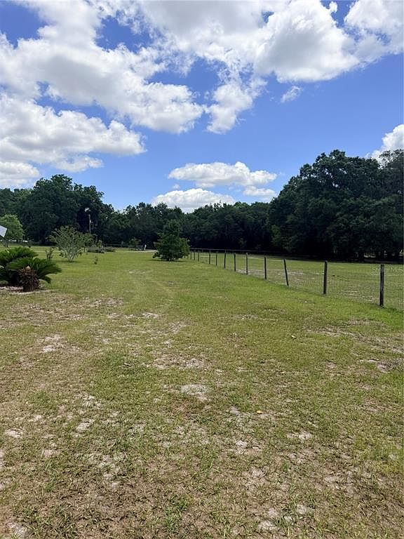 Open pasture with wire fencing and mature shade trees
