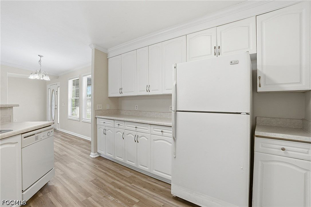 Kitchen showing white cabinet detail and laminate countertops