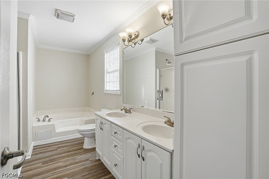 Primary bathroom with double vanity and built-in soak tub