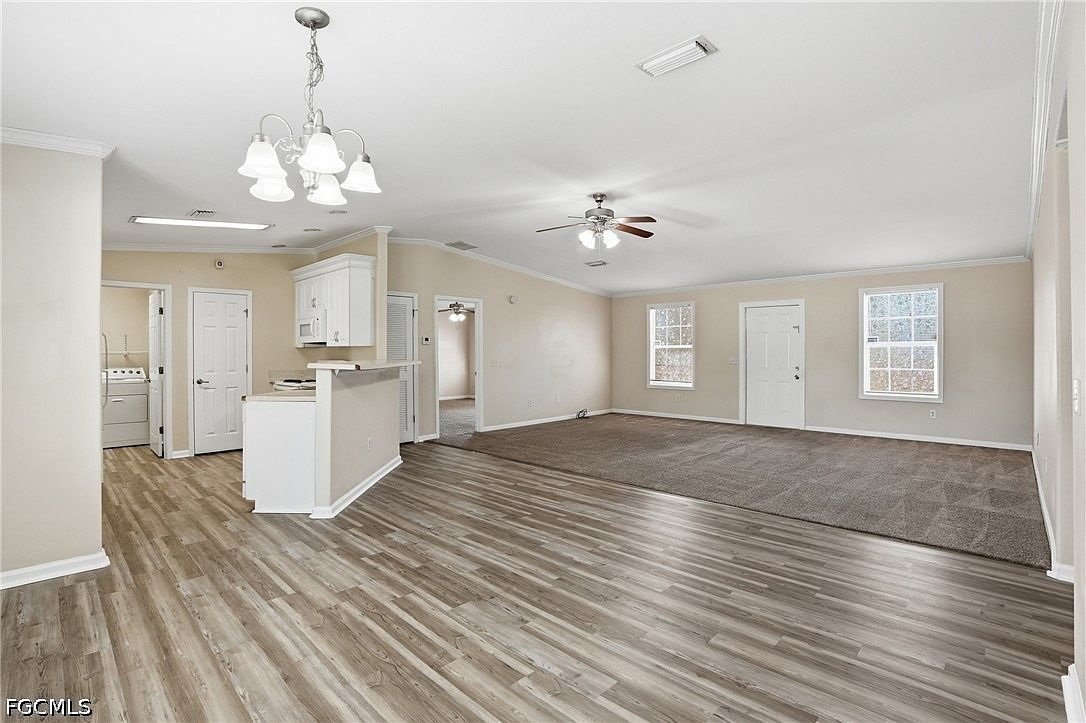 Wide-angle view of the main living, dining, and kitchen area