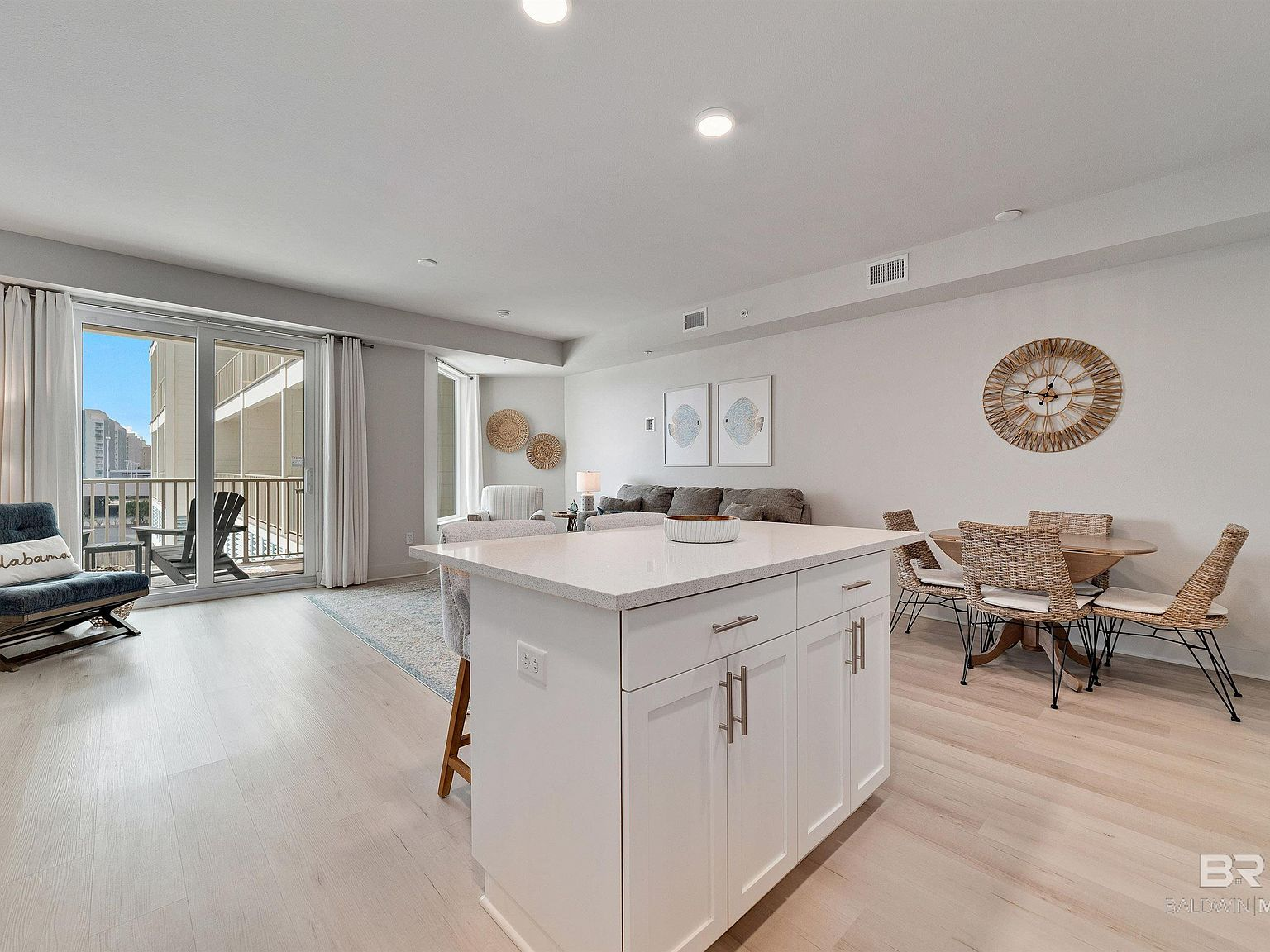 Open-concept kitchen, dining, and living area with balcony access