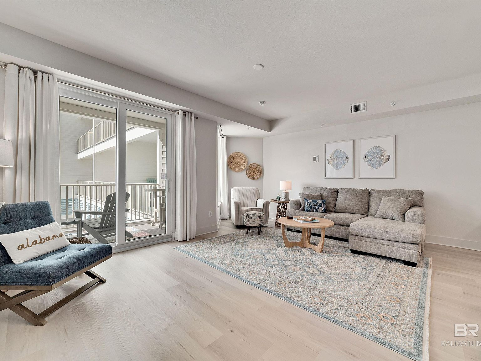 Bright coastal living room with high ceilings and natural daylight