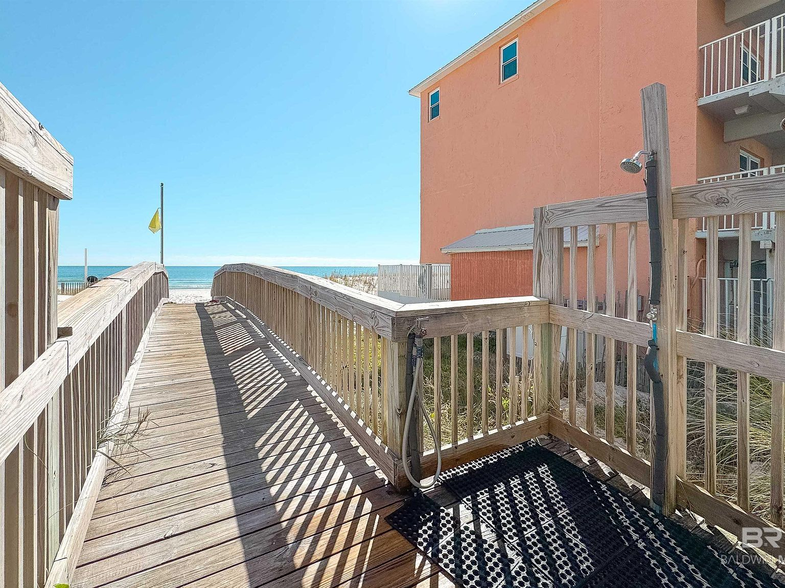 Beach access boardwalk with outdoor shower