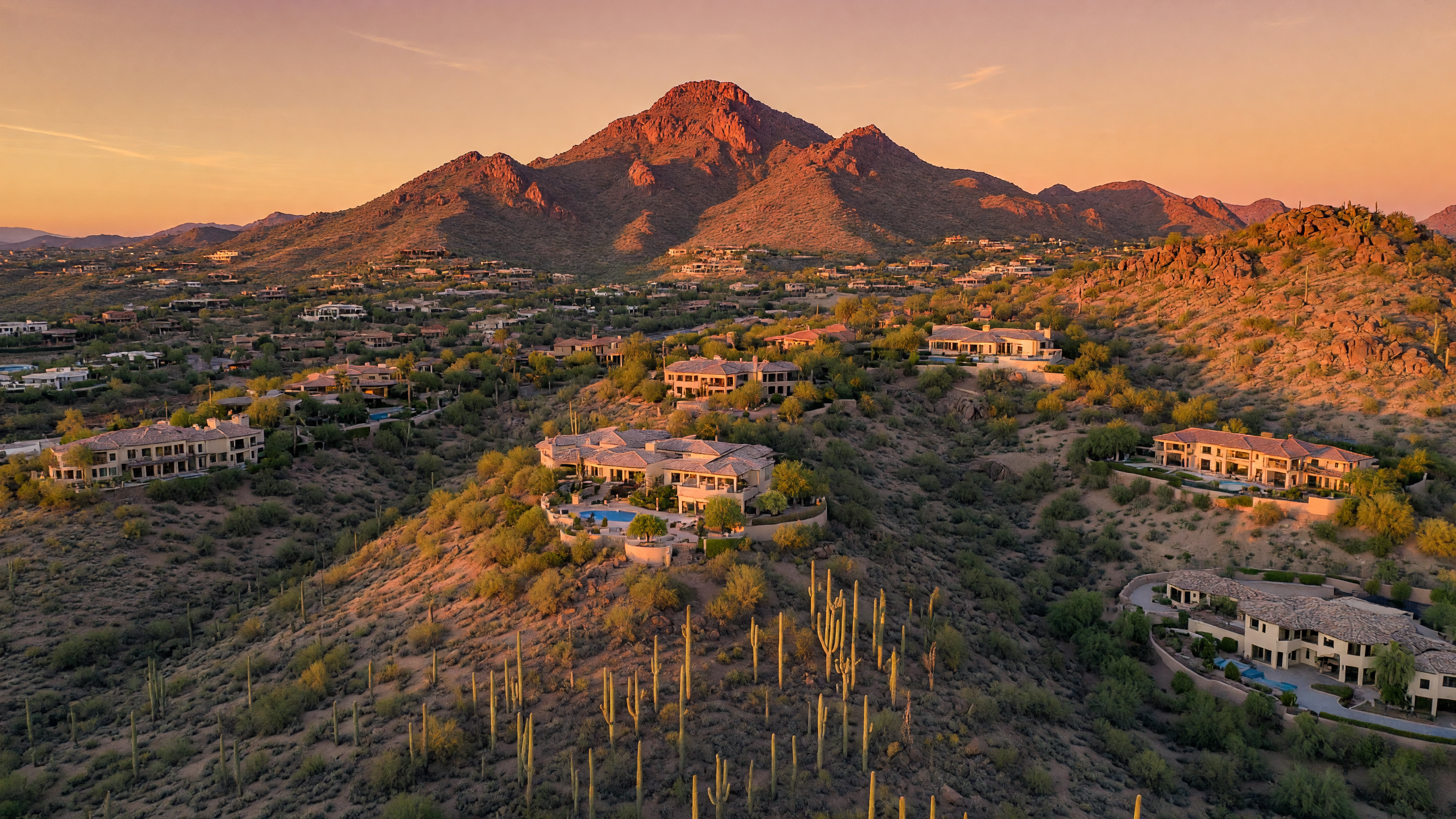 Aerial view of Paradise Valley luxury estates at golden hour with Camelback Mountain in the background