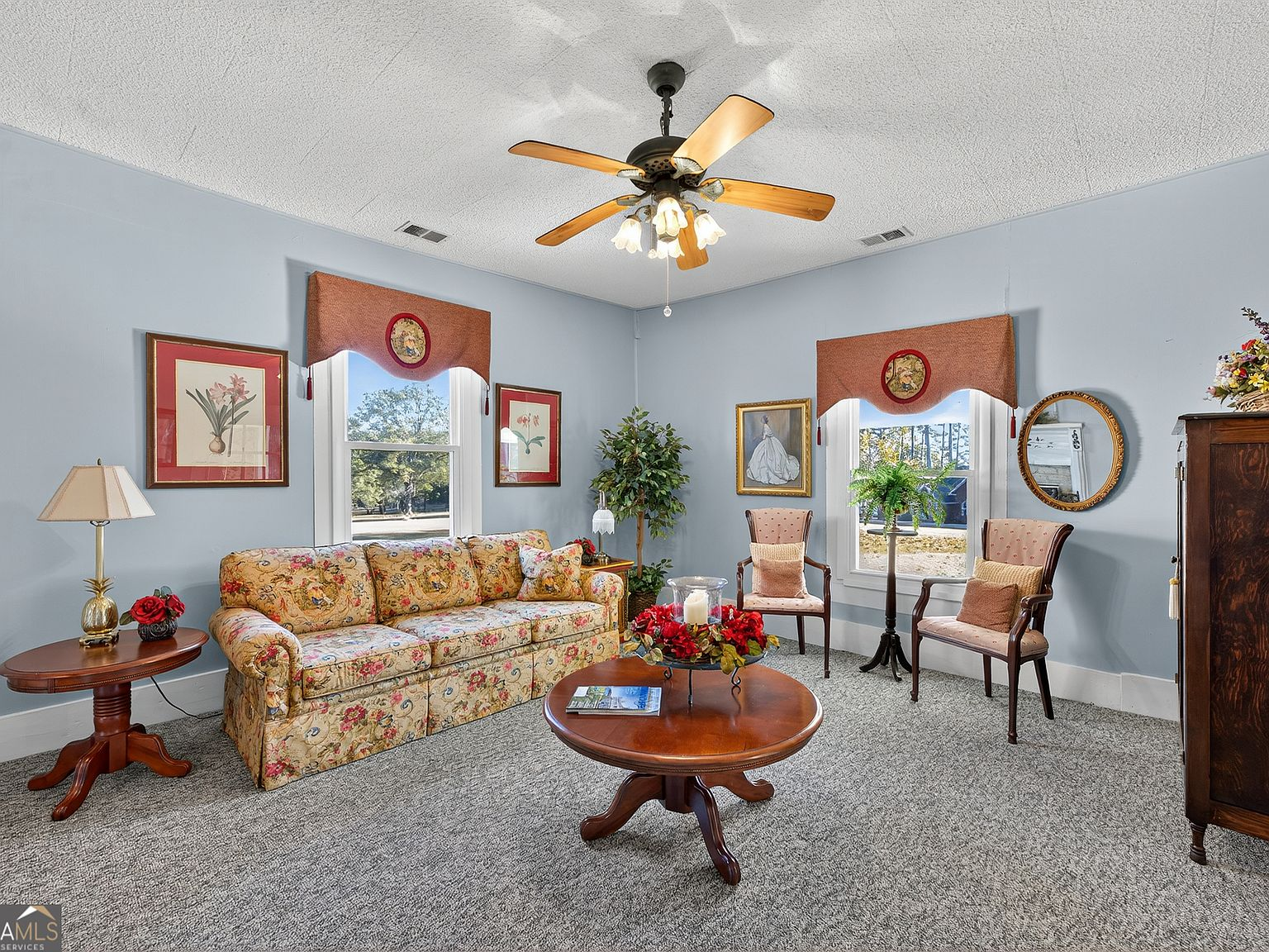 Living room with light blue walls, natural daylight, and historic character