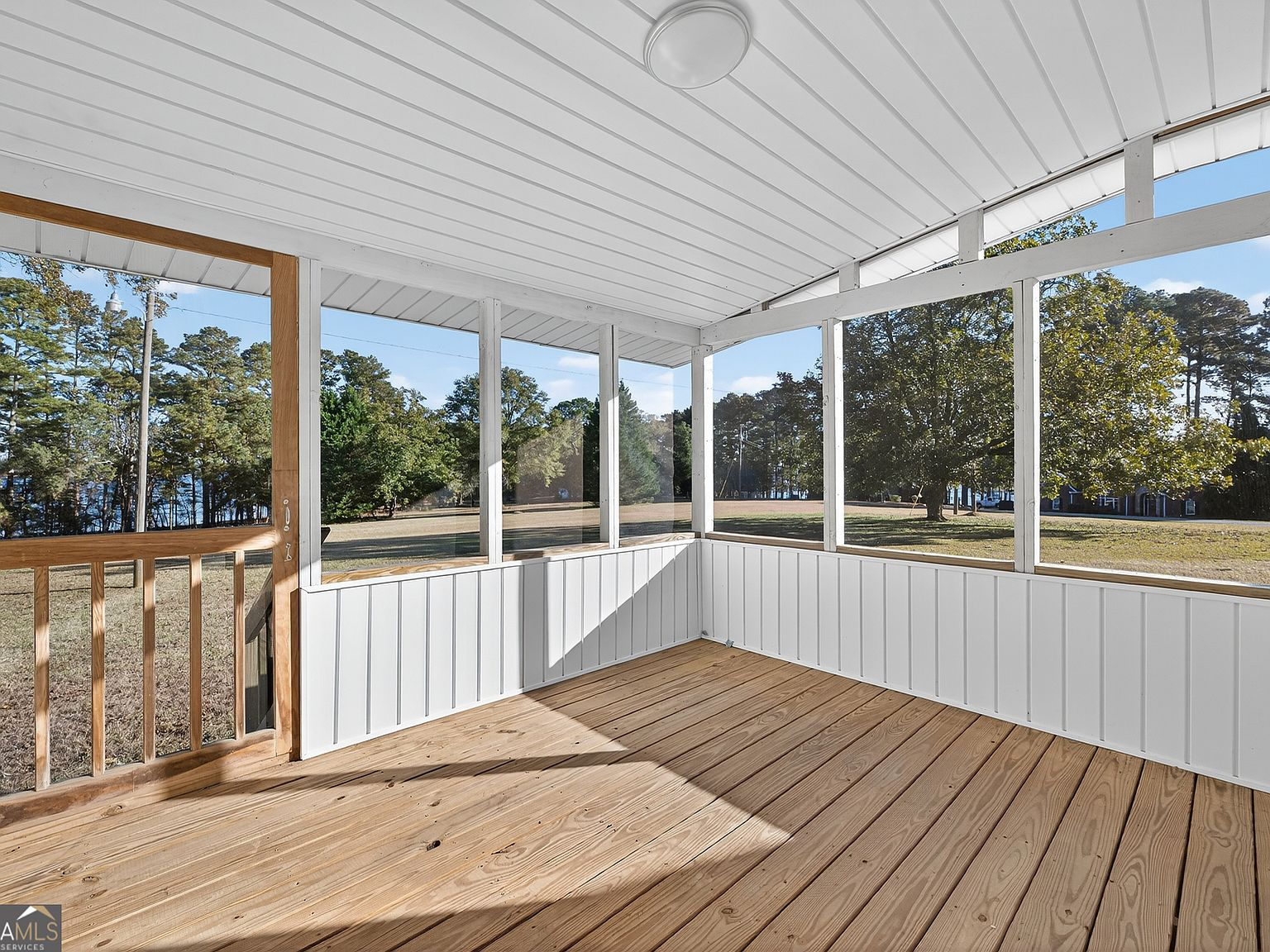 Screened back porch overlooking the grassy backyard and Lake Hartwell