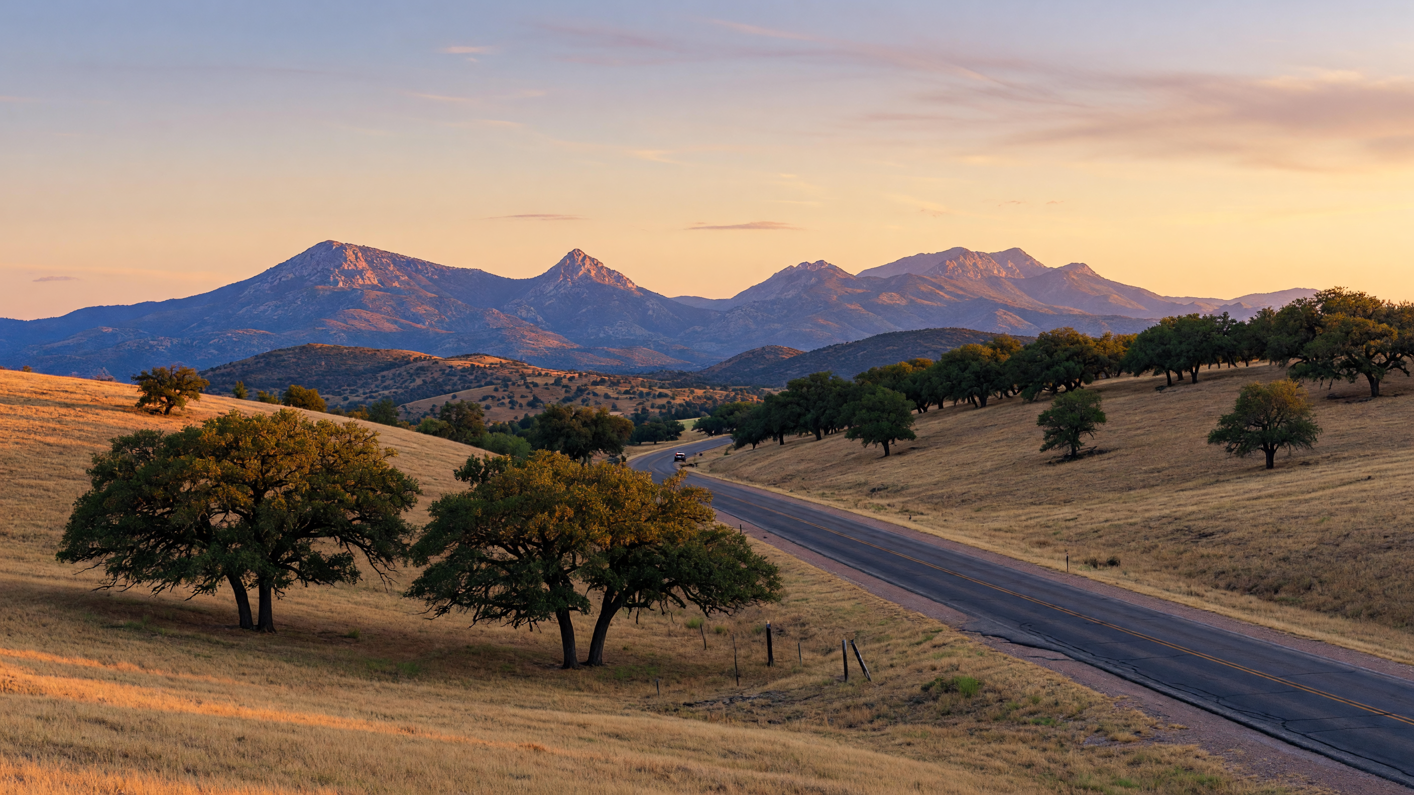 Scenic landscape near Fort Sill, Oklahoma with rolling hills and the Wichita Mountains in the distance