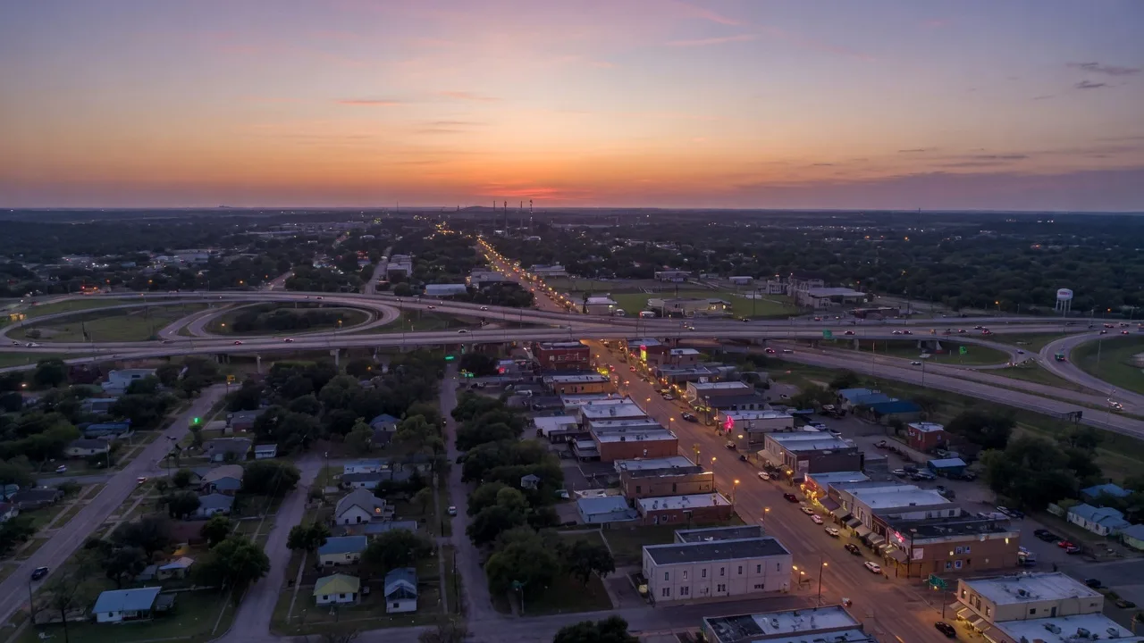 Aerial view of Paris, Texas at twilight showing the commercial corridor and residential neighborhoods