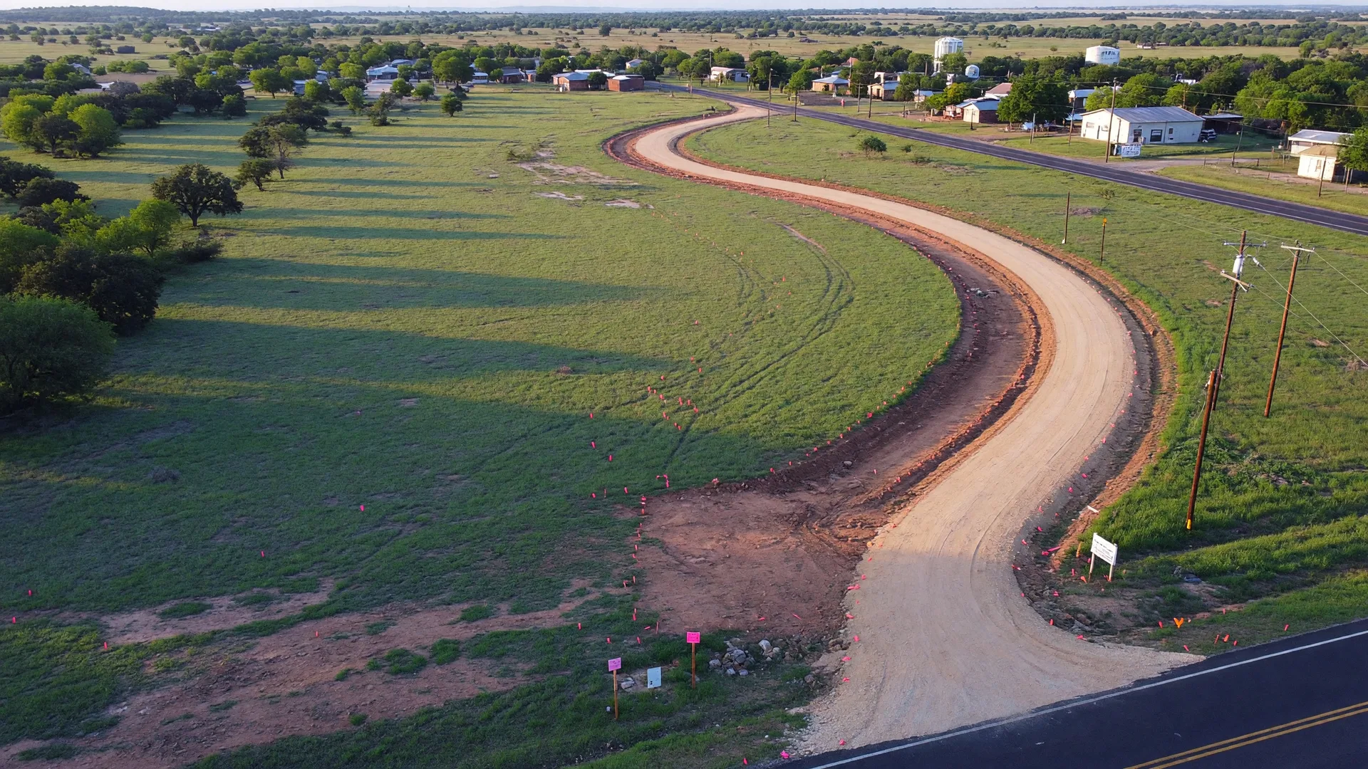 Aerial view of a large undeveloped industrial tract in a Texas county with survey markers and access road