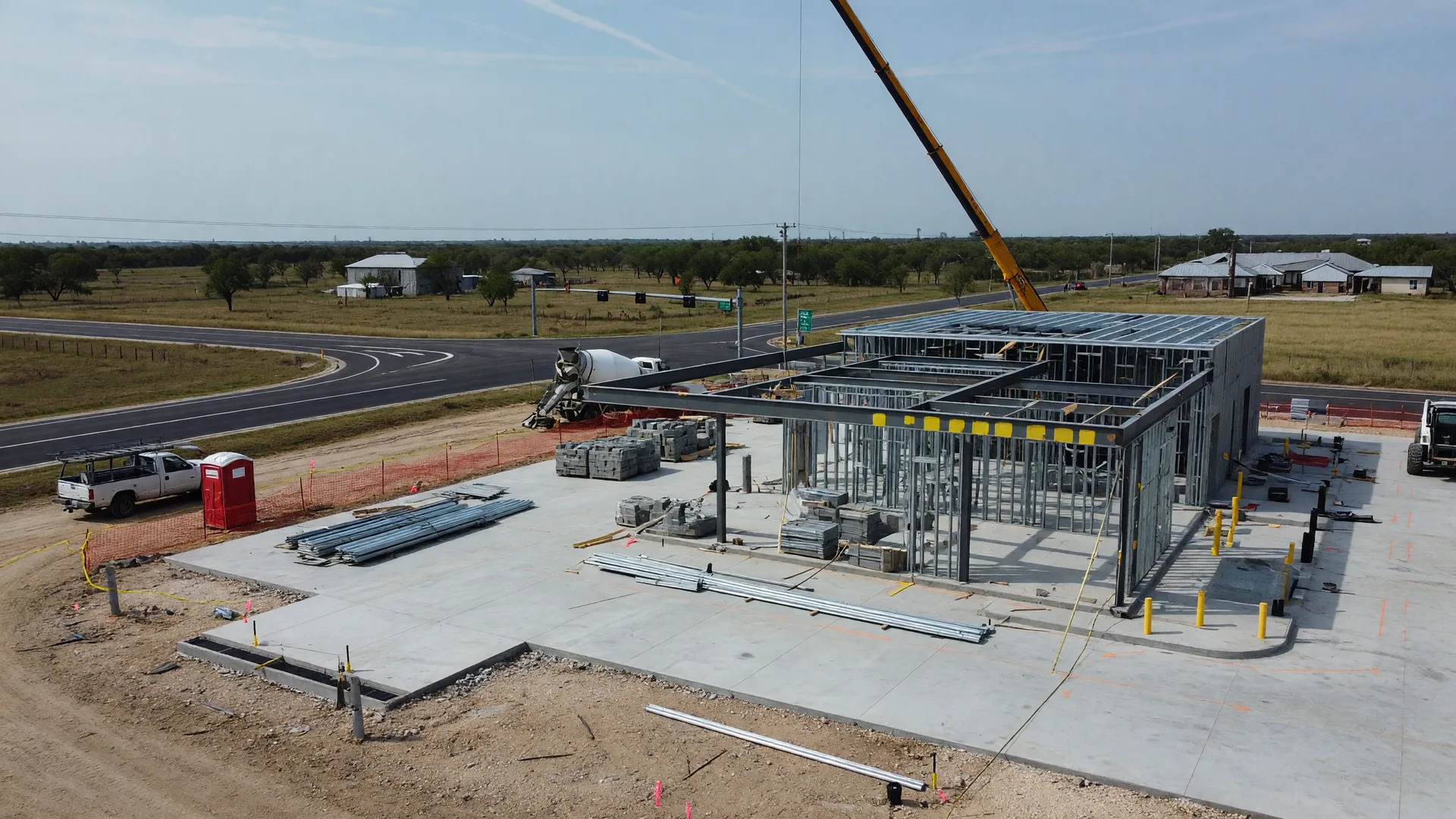 A new residential subdivision development in rural North Texas showing freshly paved streets and newly constructed single-family homes under a wide open sky