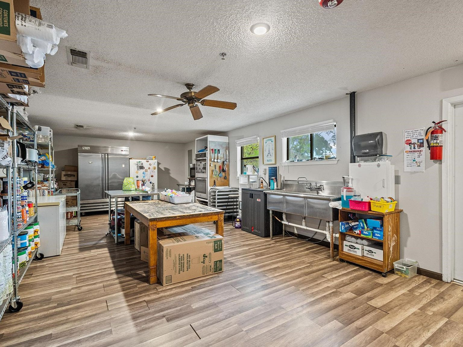 Commercial kitchen with stainless steel equipment and prep areas