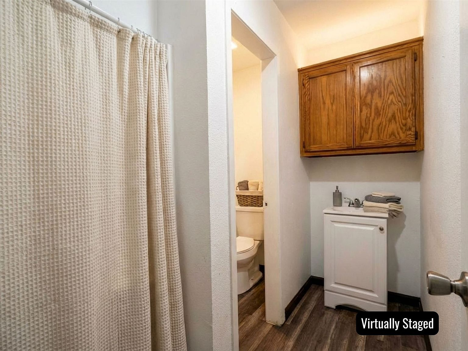 Clean commercial bathroom with vanity and wood-look flooring