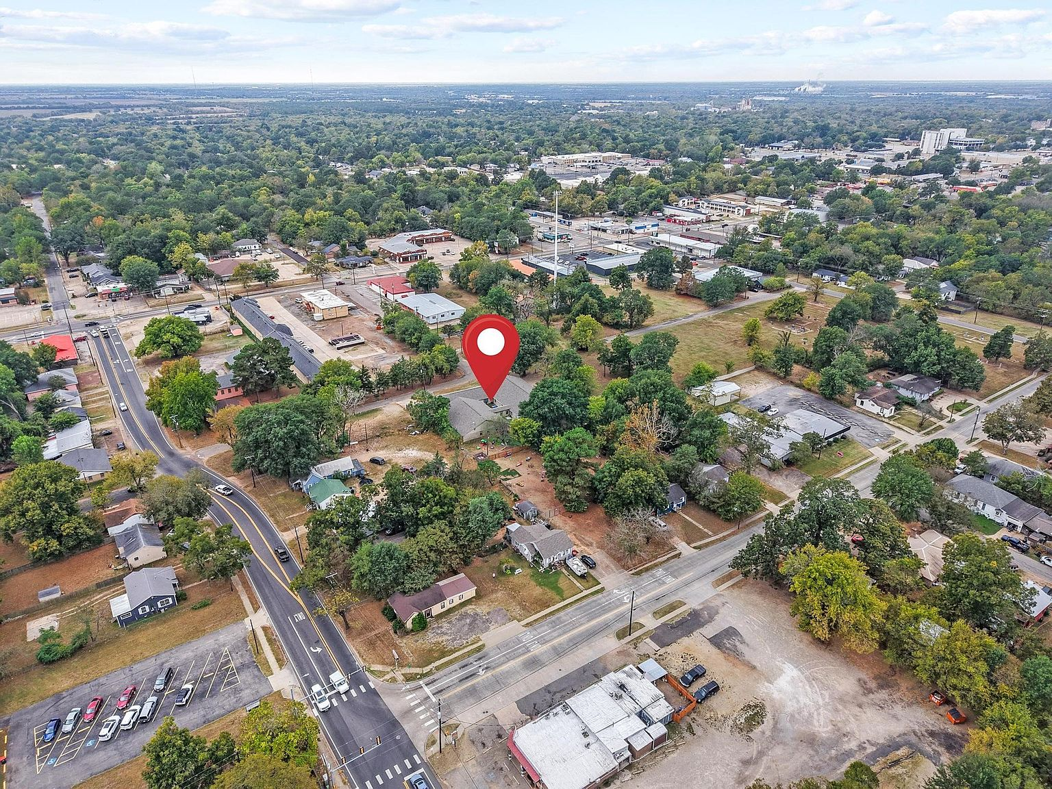 High-altitude aerial showing the property lot and surrounding neighborhood context