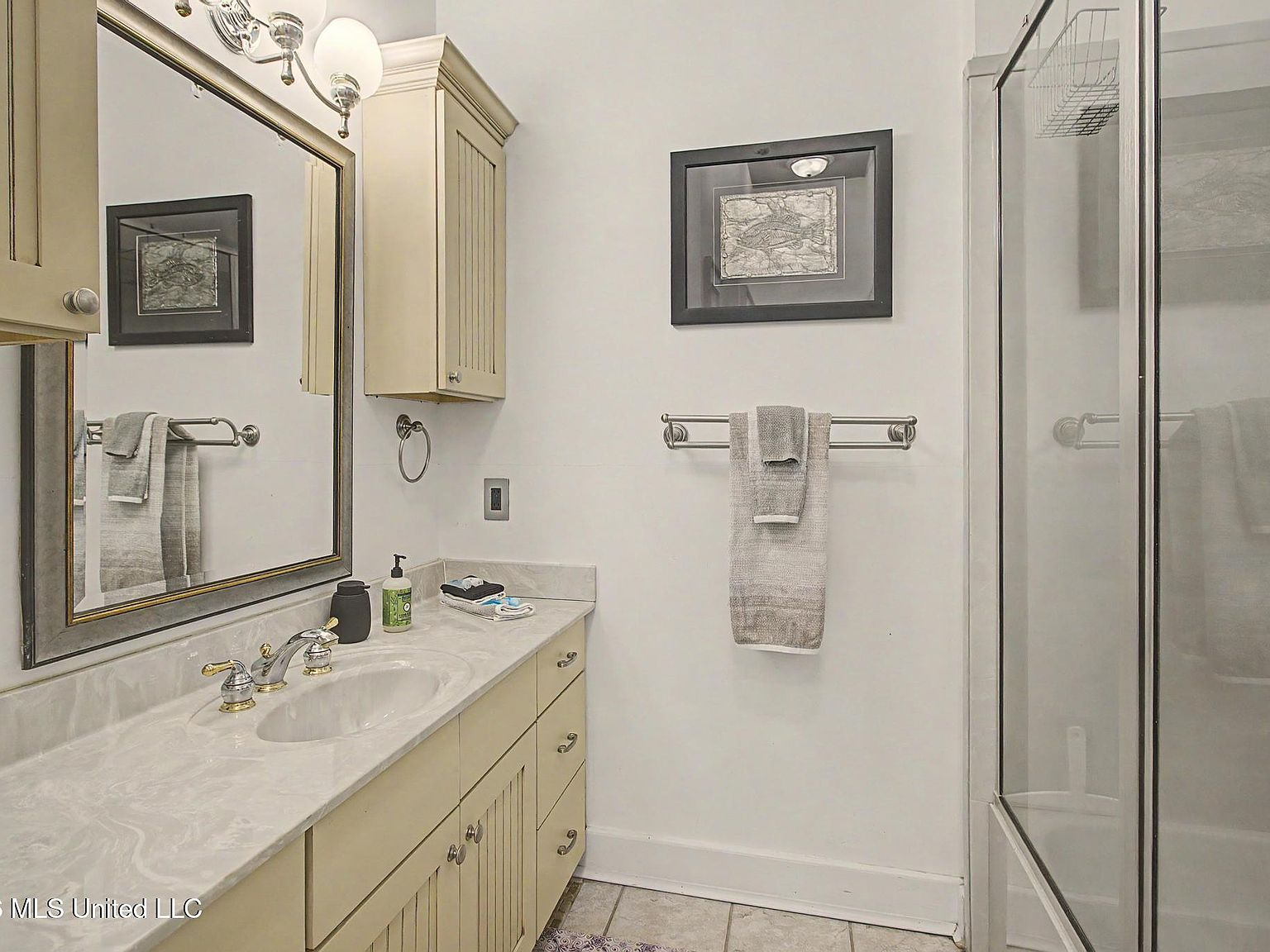 Bathroom with updated vanity and glass-enclosed shower