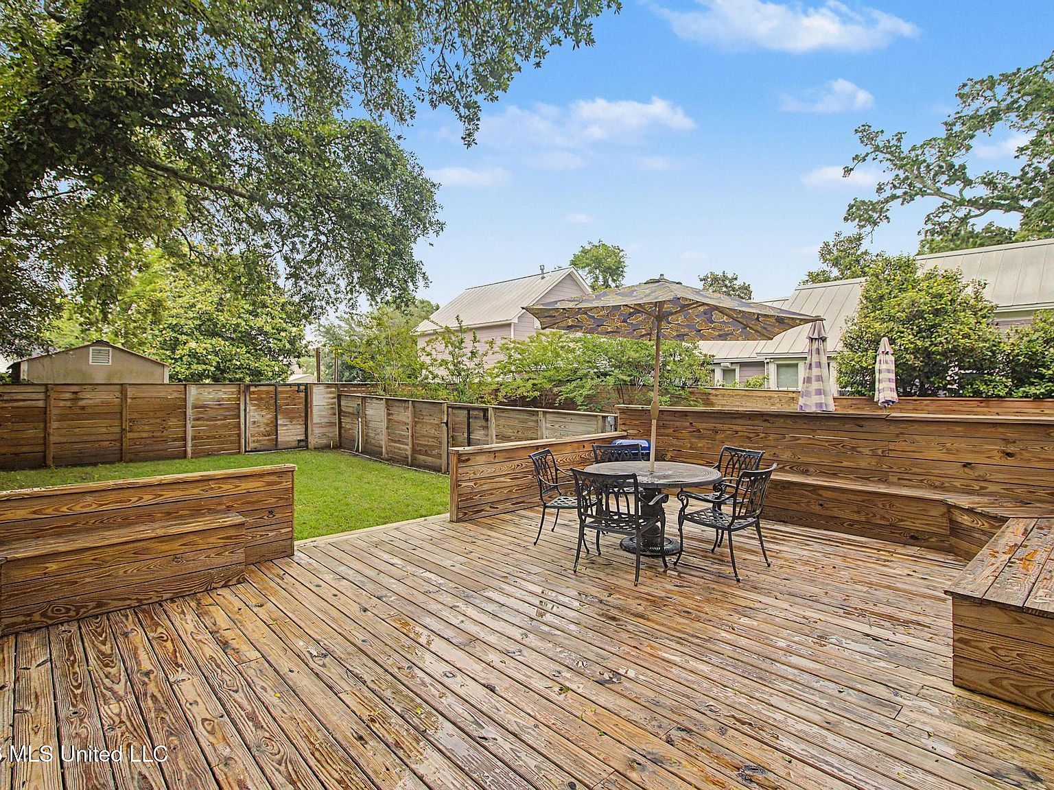 Backyard wooden deck with patio seating
