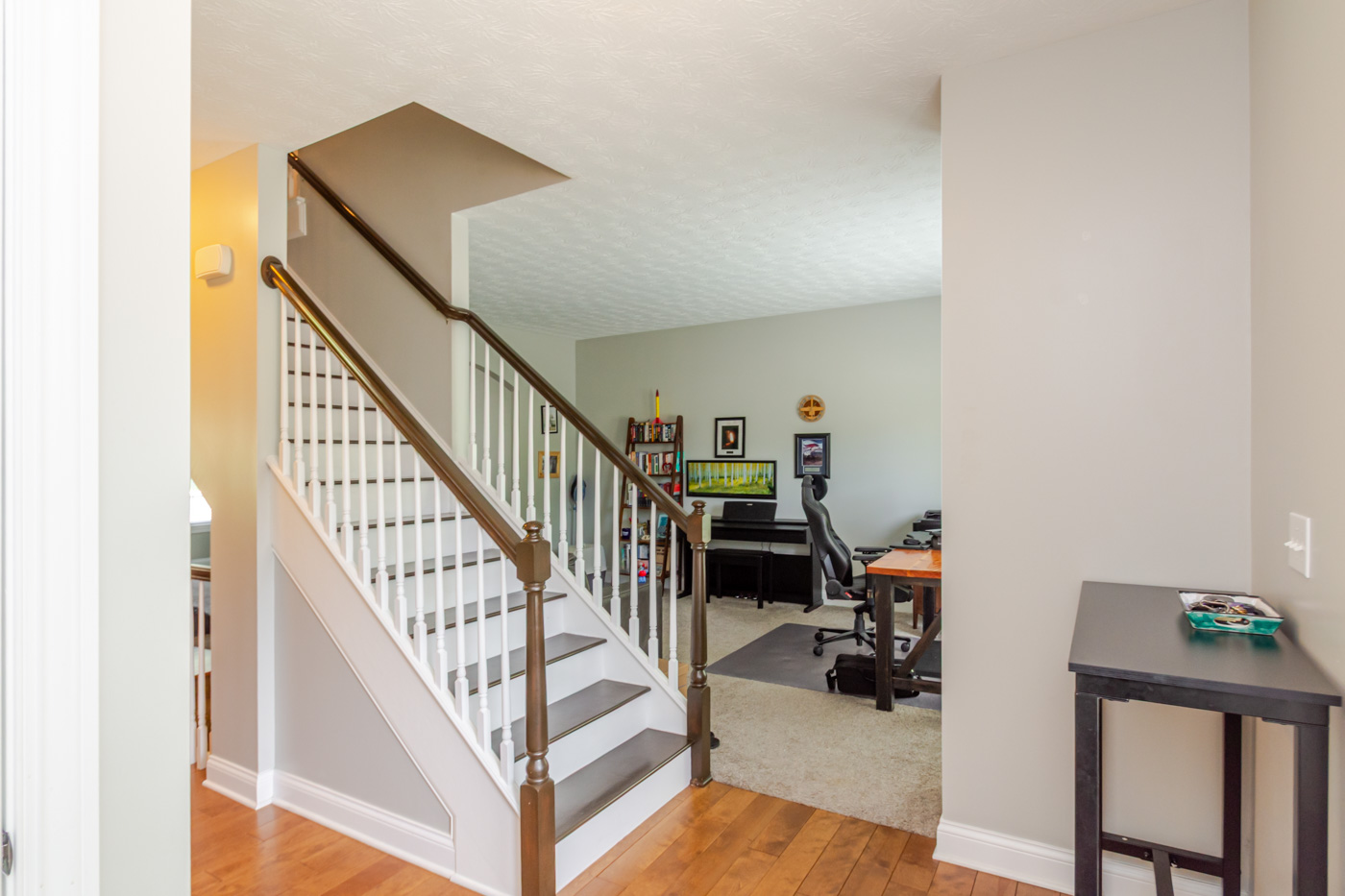 Foyer and main staircase with hardwood floors