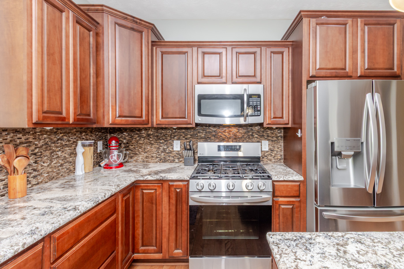 Cherry wood cabinetry and granite countertop detail