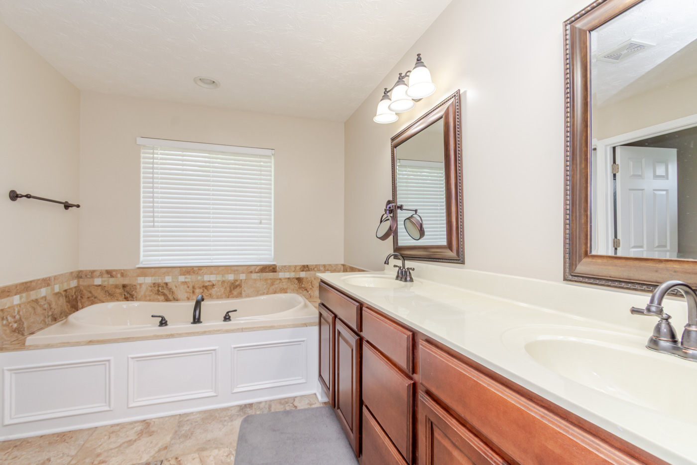 Primary bathroom with double vanity and garden tub