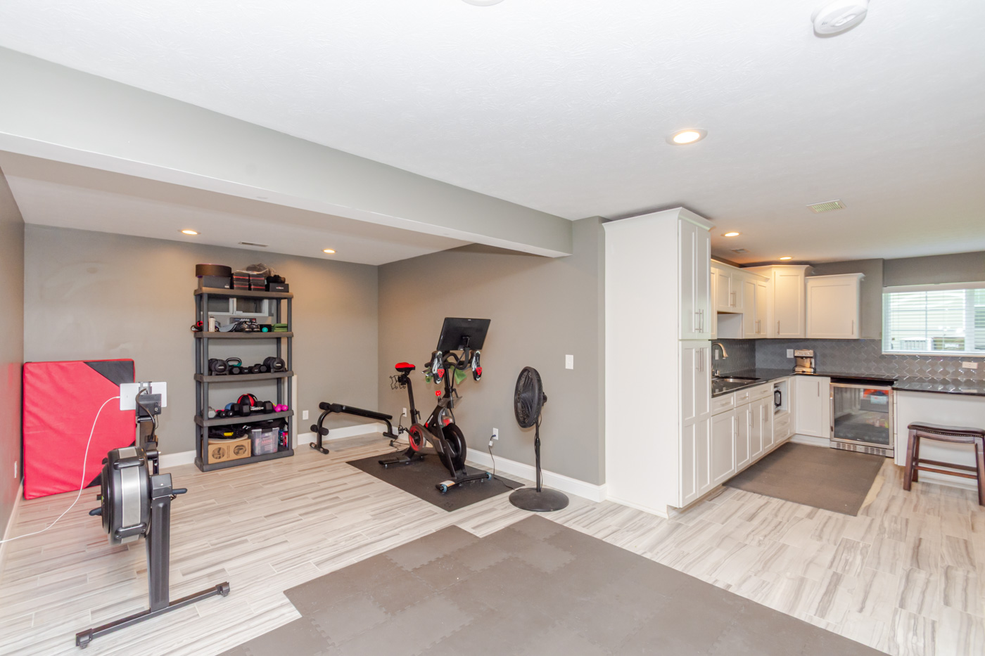 Finished lower level configured as a home gym with kitchenette