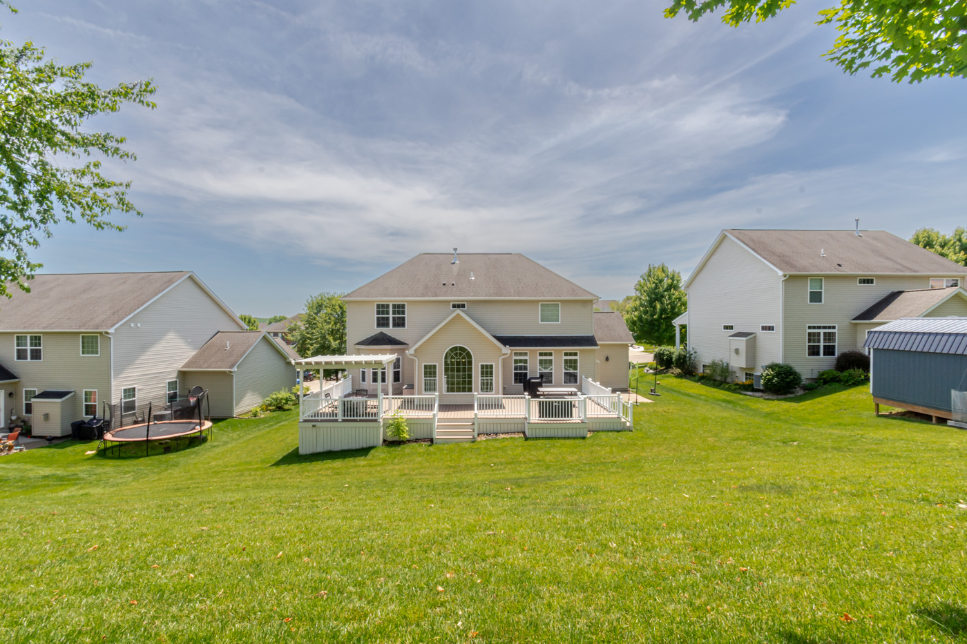 Backyard lawn and rear facade view