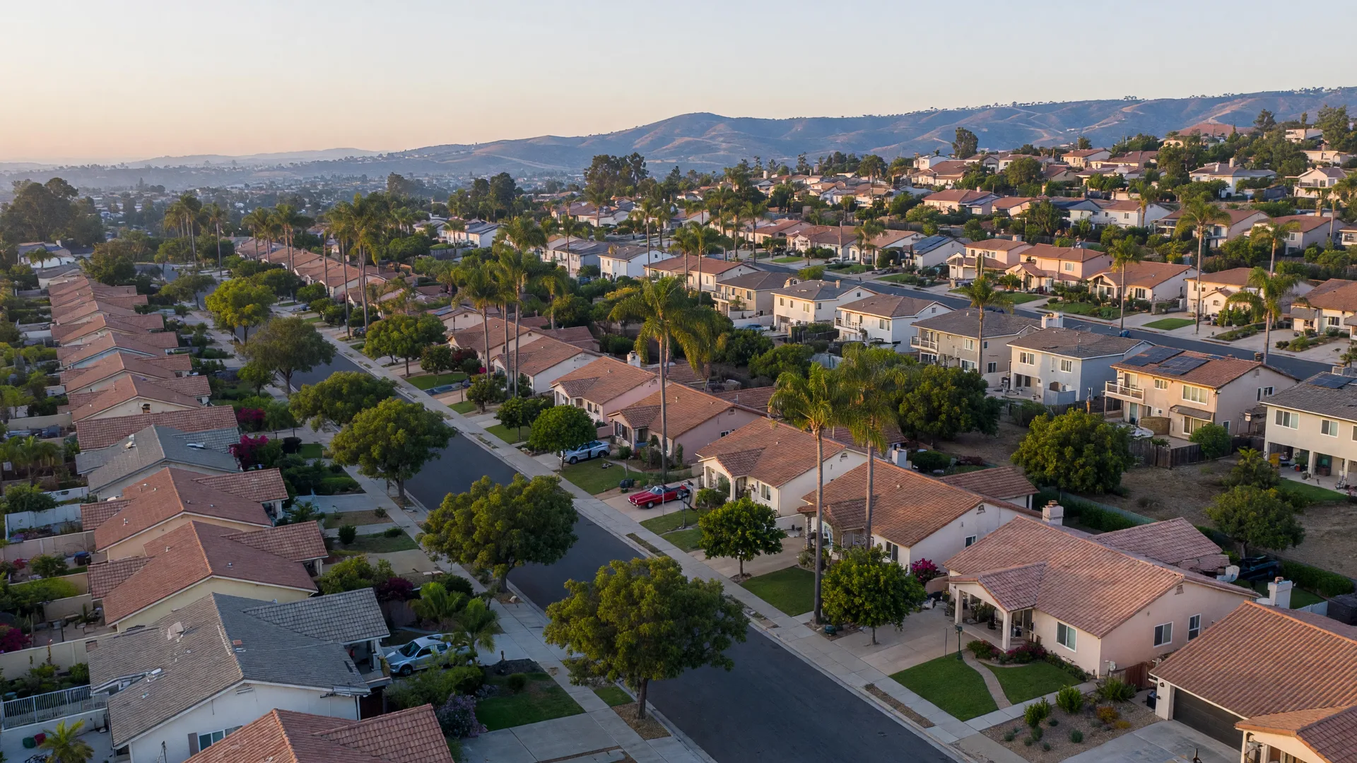 San Diego residential neighborhood with tree-lined streets and homes stretching toward distant hills