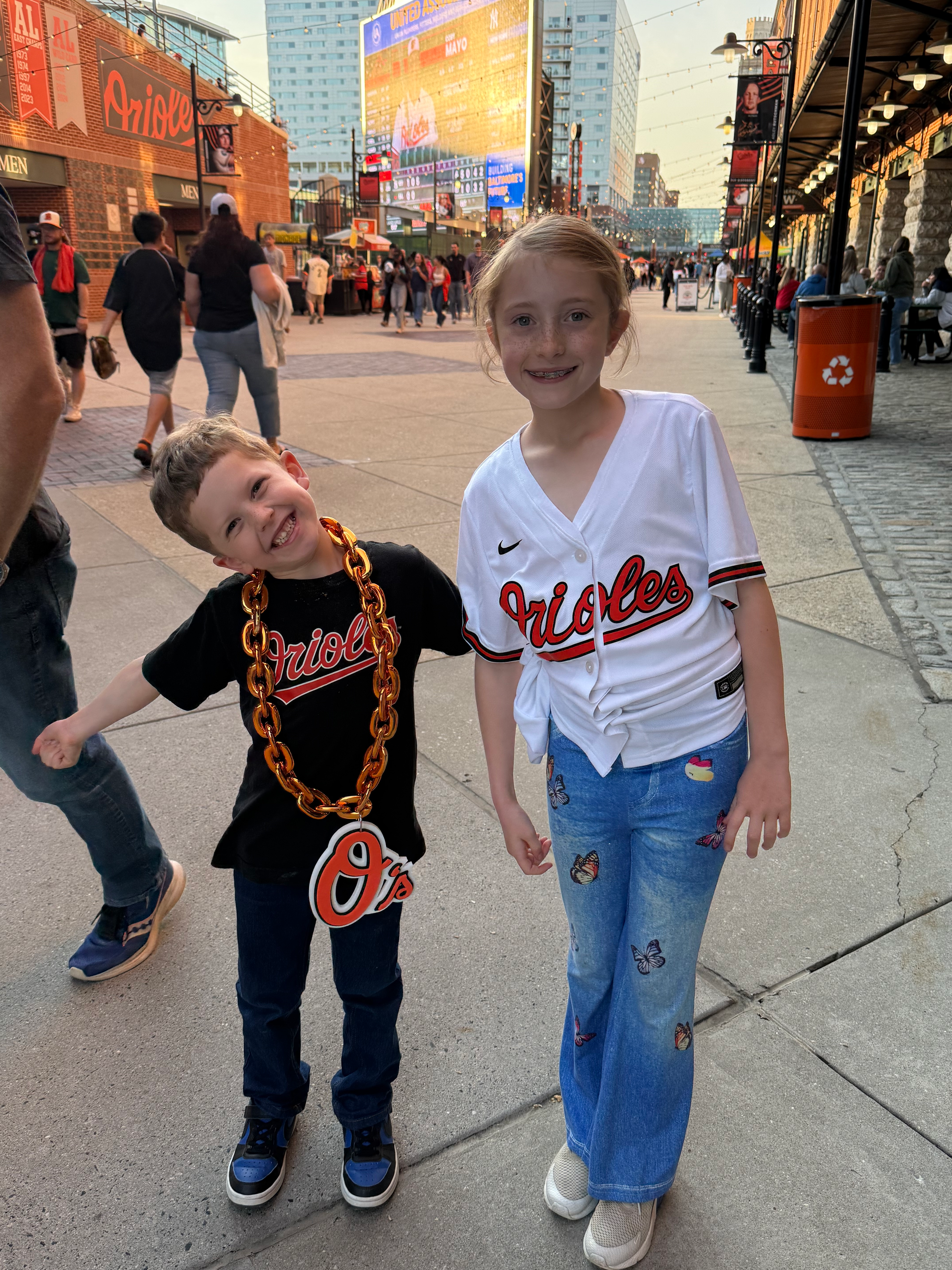 Children in Baltimore Orioles apparel at a baseball stadium