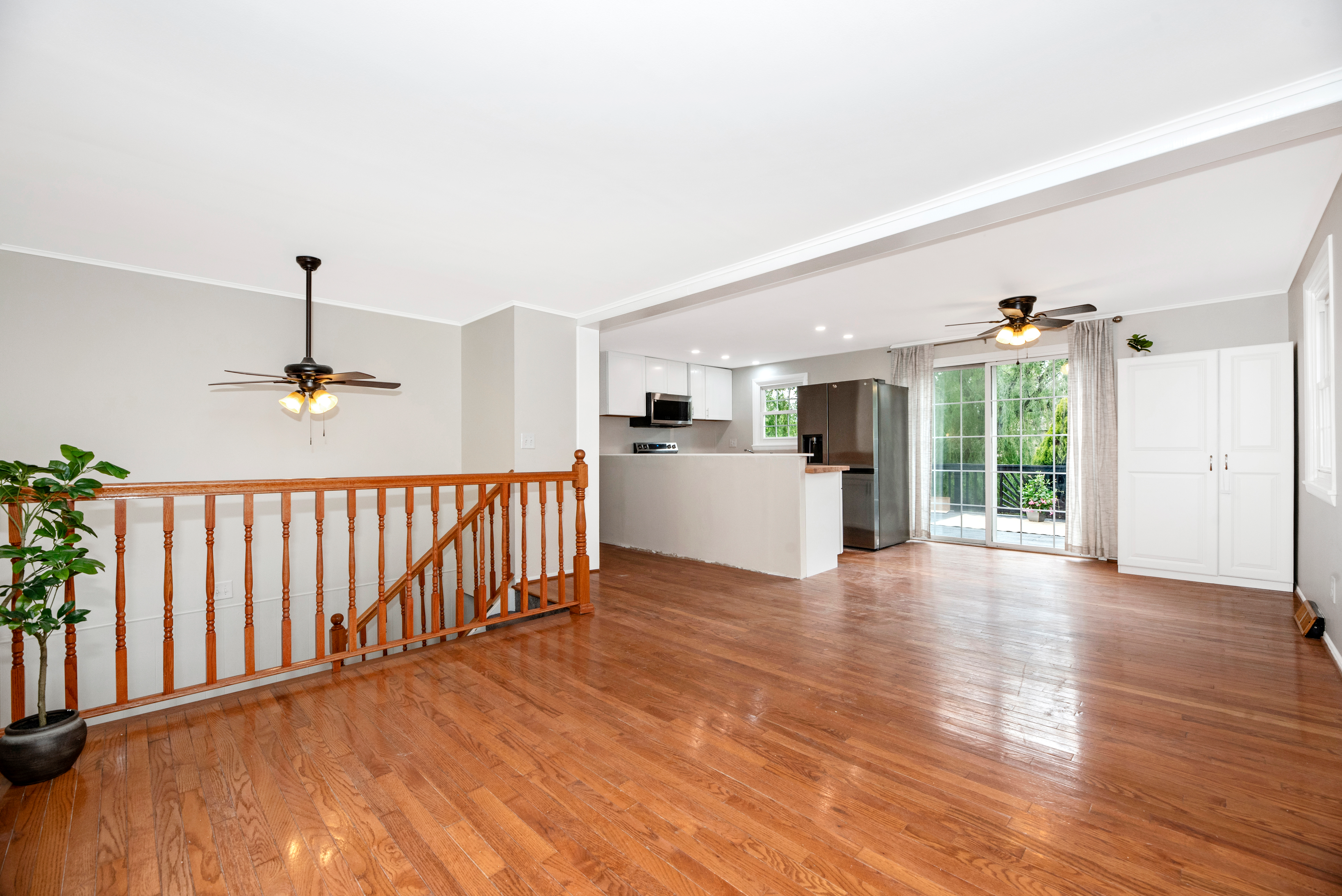 Open-plan home interior with hardwood floors and a view into the kitchen
