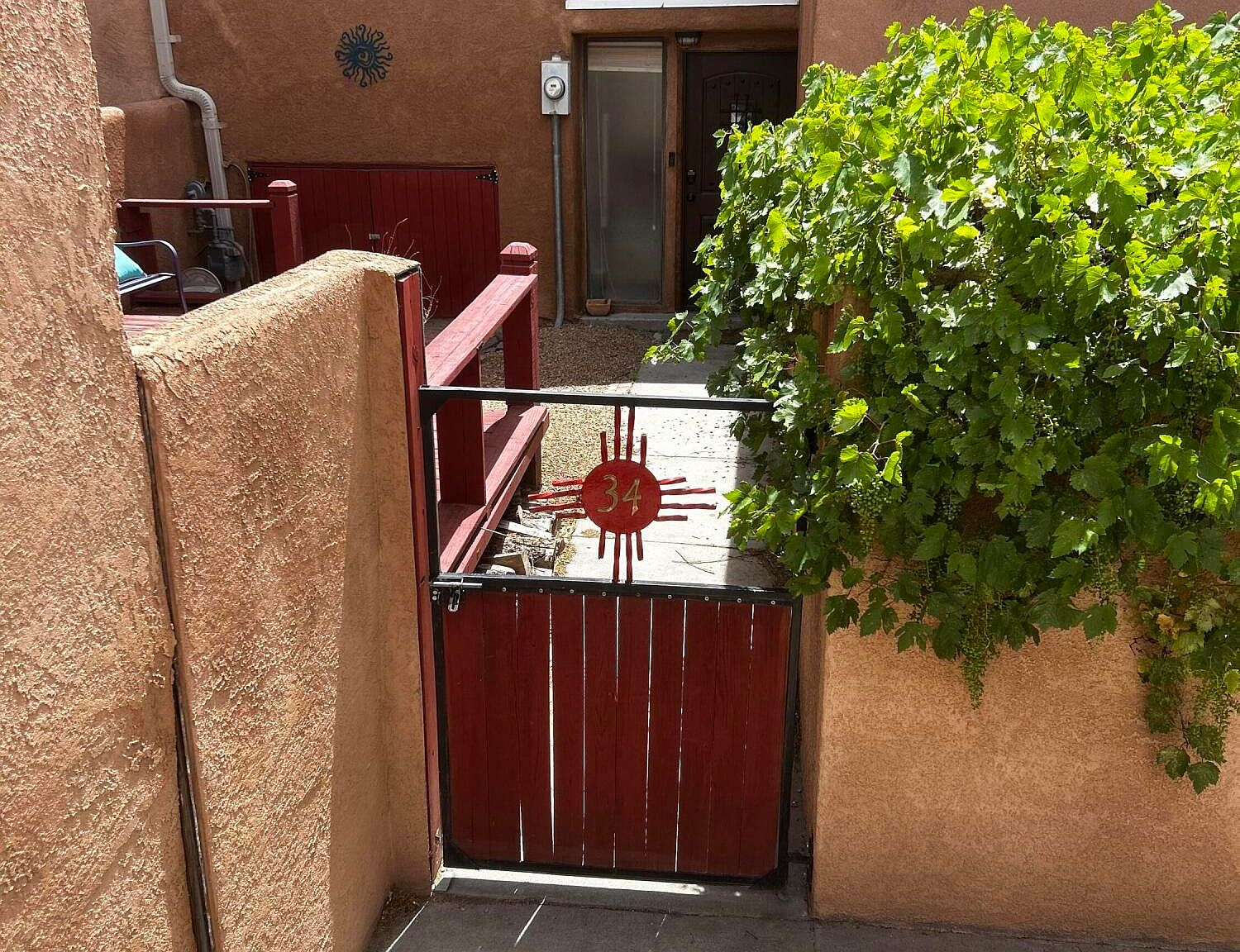 Front entryway gate with Zia sun symbol
