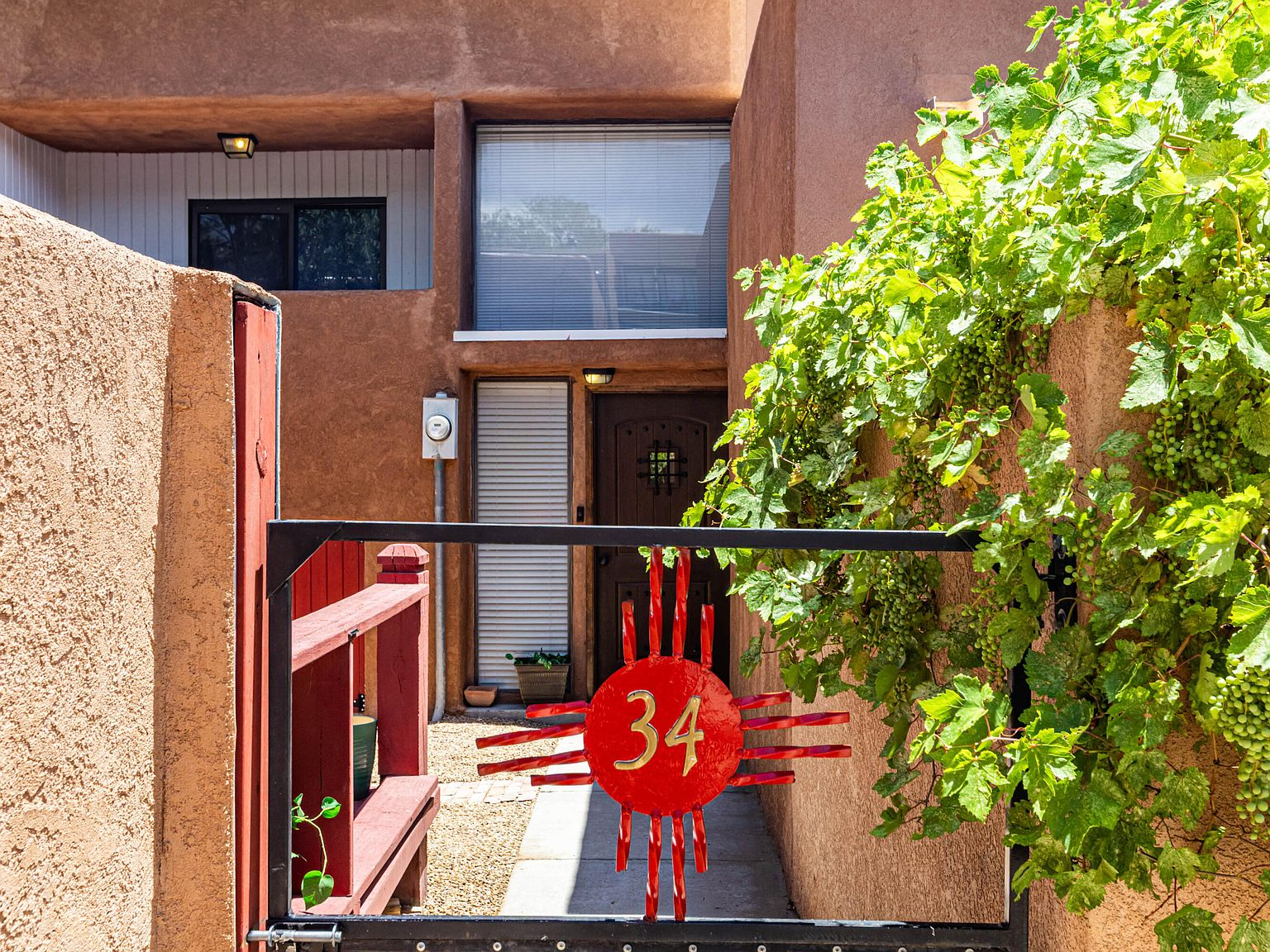 Courtyard entry with gate and front door porch