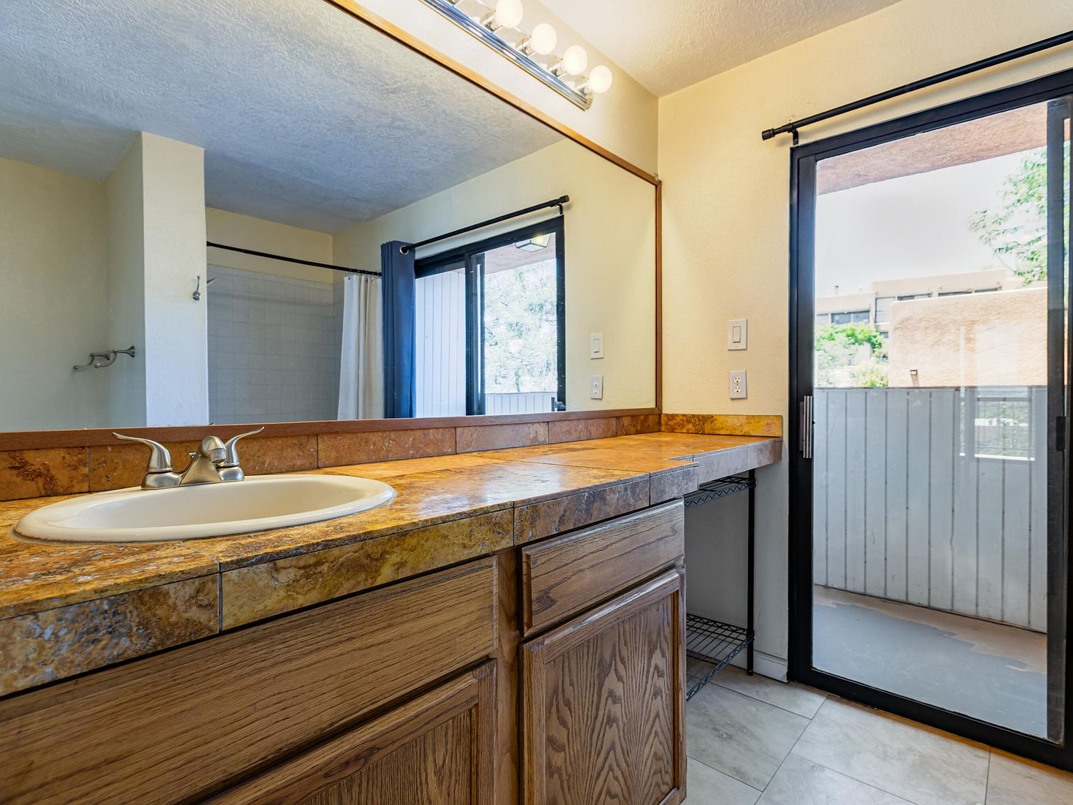 Bathroom with vanity and sliding door to balcony
