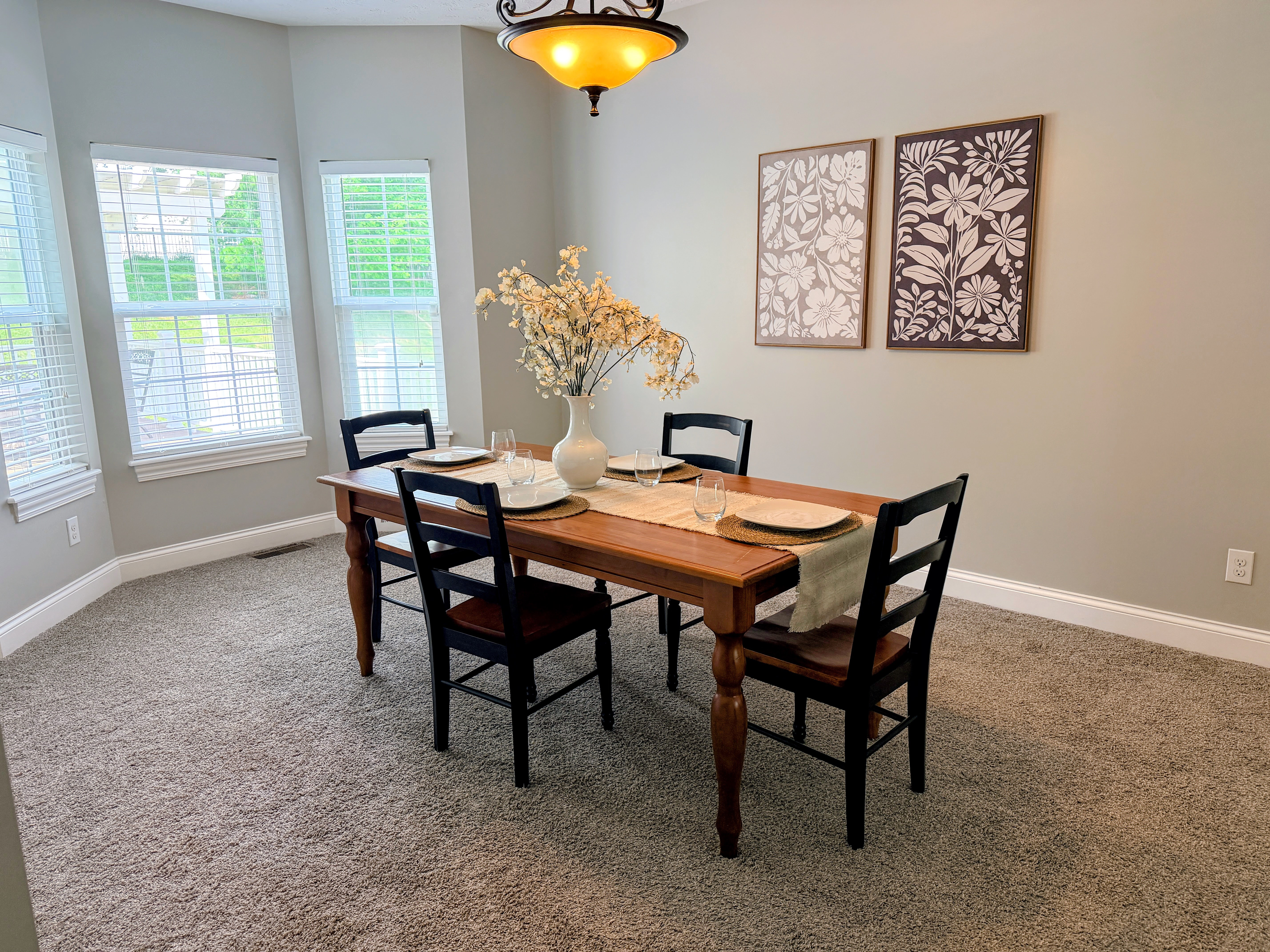 Formal dining room with bay window, chandelier, and natural light