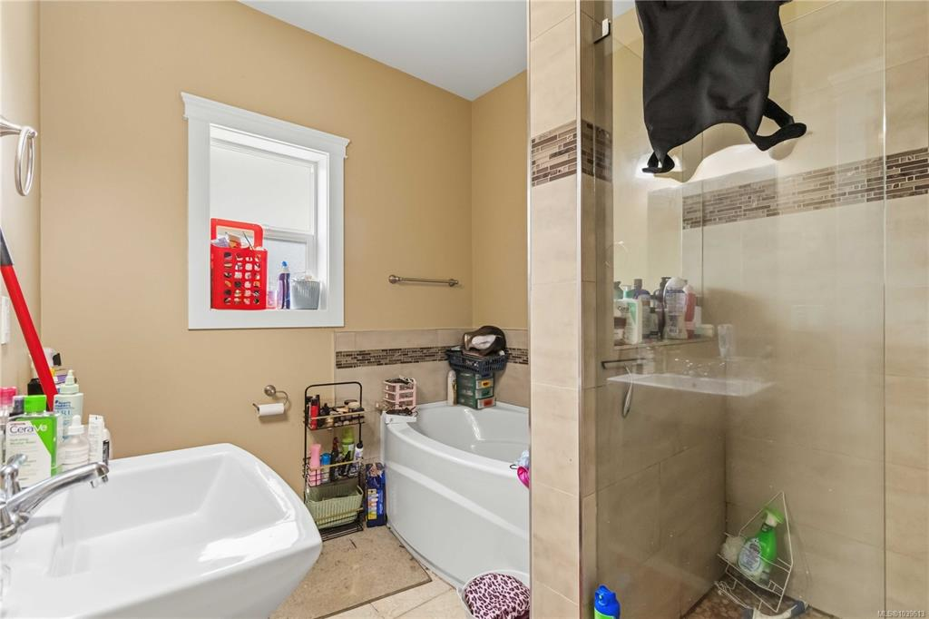 Bathroom layout with vanity area and glass-enclosed walk-in shower