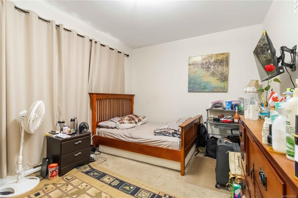 Standard bedroom with side window and beige carpeting