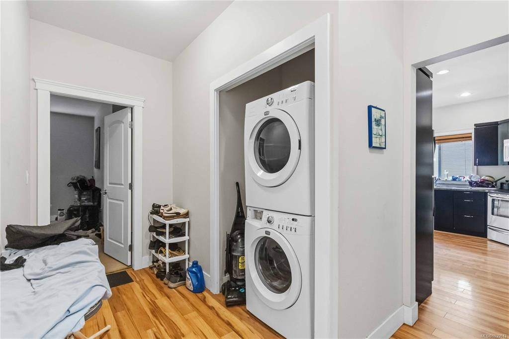 Utility and laundry room with stacked Maytag washer and dryer