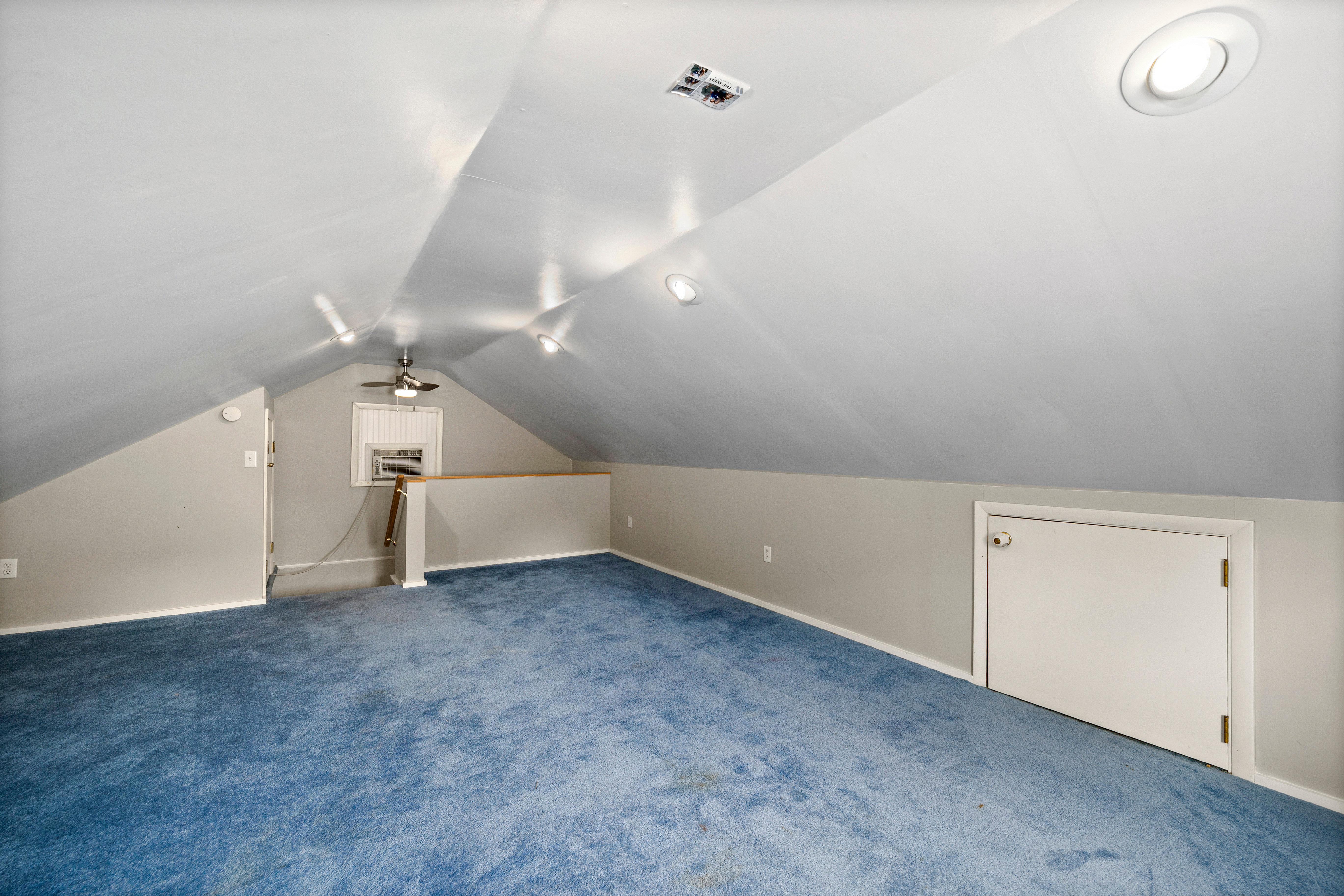 Attic bonus space with sloped ceilings and recessed lighting