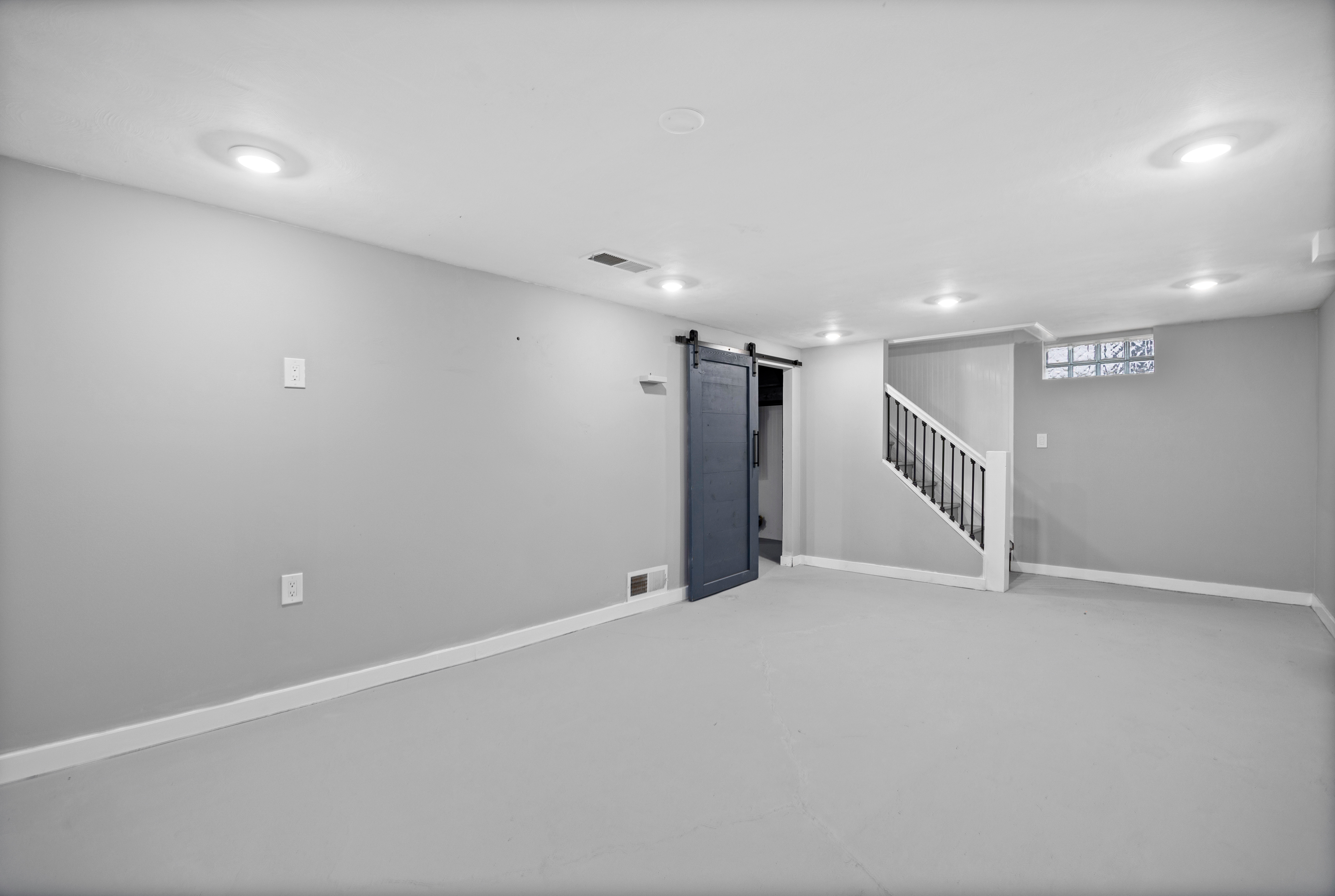 Basement rec room with luxury vinyl plank flooring