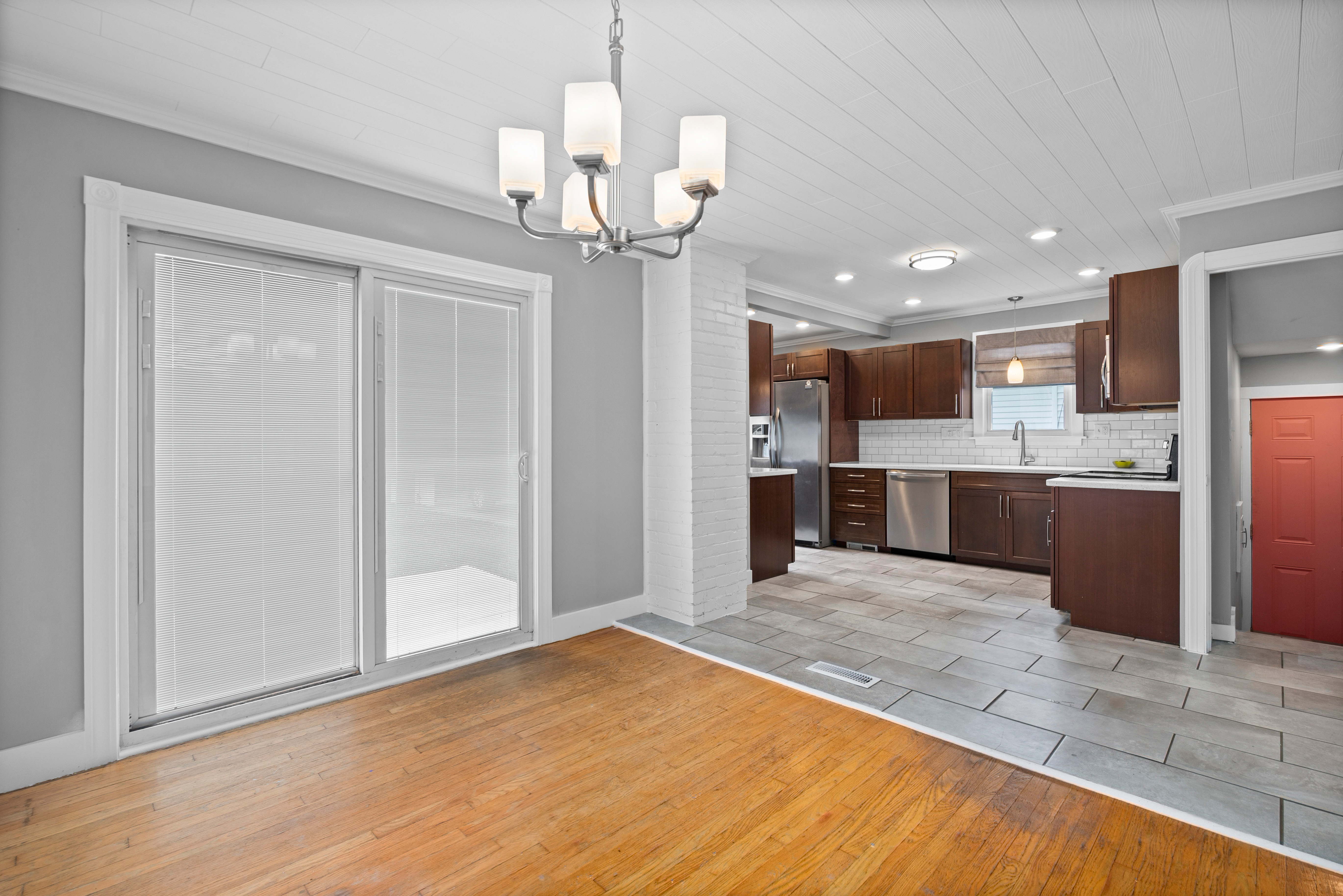 Open kitchen and dining area with shiplap ceiling