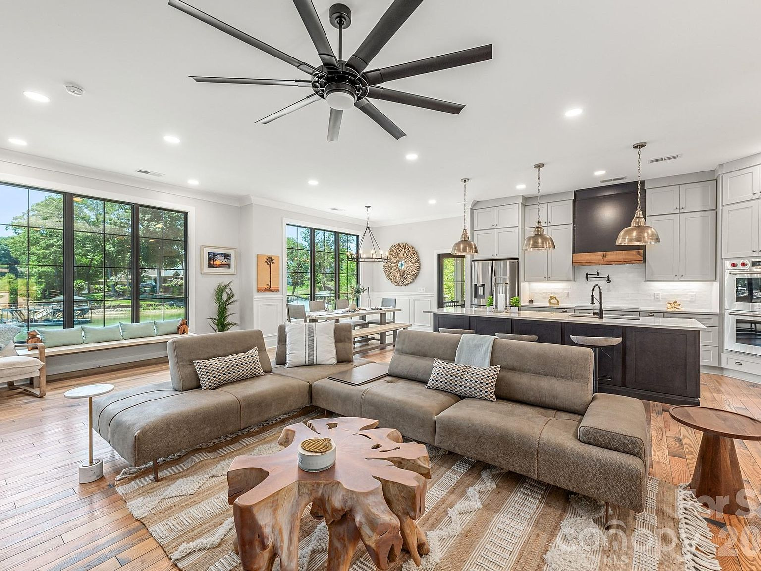 Open-concept living area with hardwood floors, neutral walls, and natural daylight