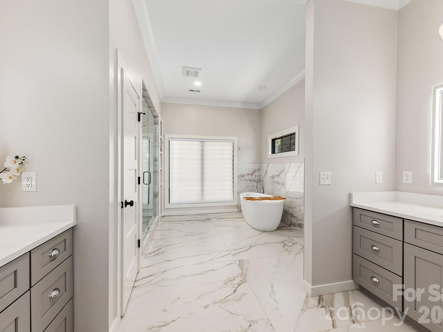 Master bathroom with freestanding soaking tub and glass-enclosed shower