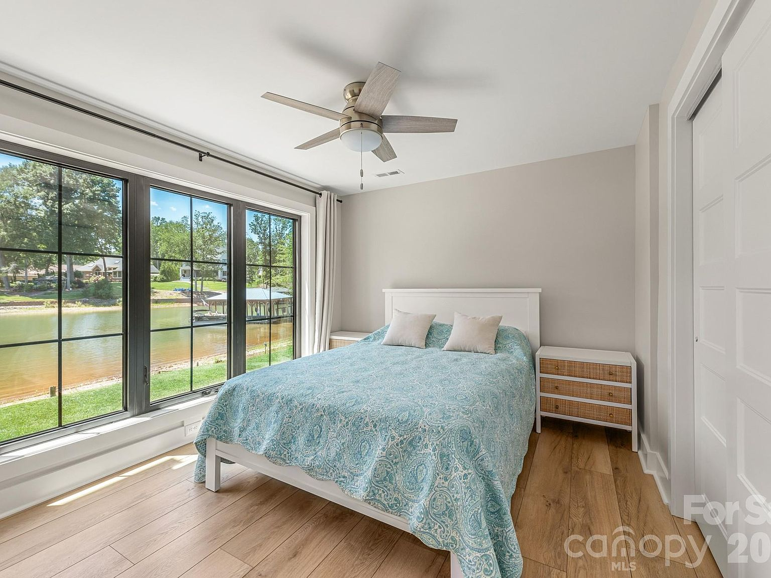 Bedroom with large windows overlooking Lake Norman