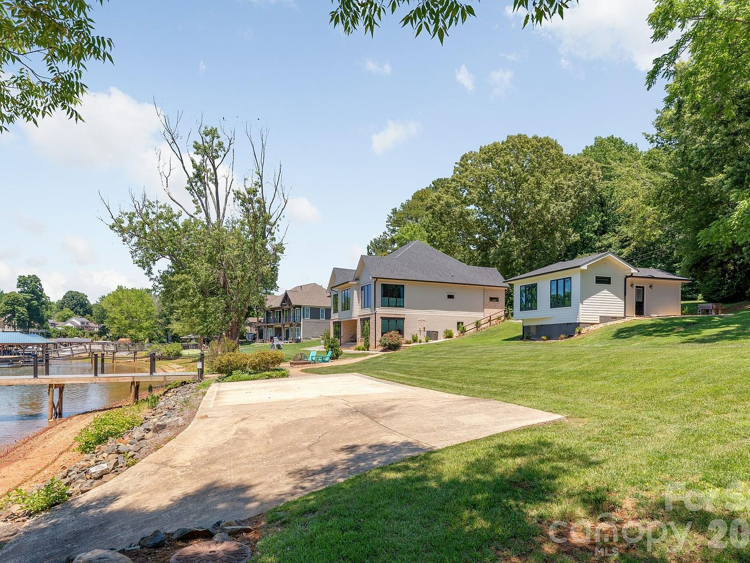 Lakefront backyard with private dock extending into Lake Norman