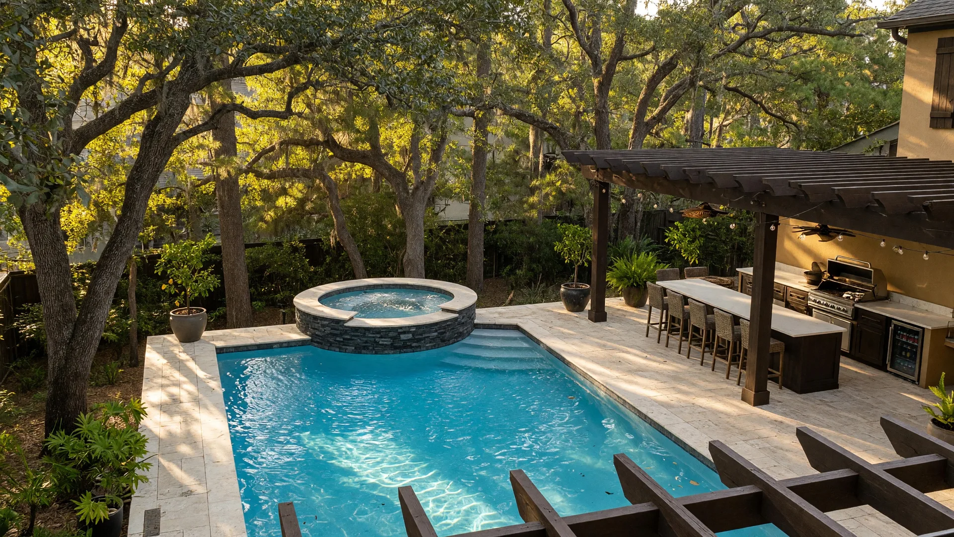 Private pool, spa, and covered outdoor kitchen at a home in The Woodlands, Texas